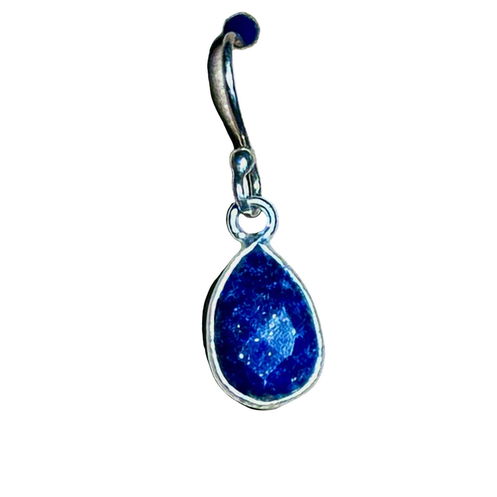 Blue Lapis Lazuli faceted teardrop earring in sterling silver setting on a background