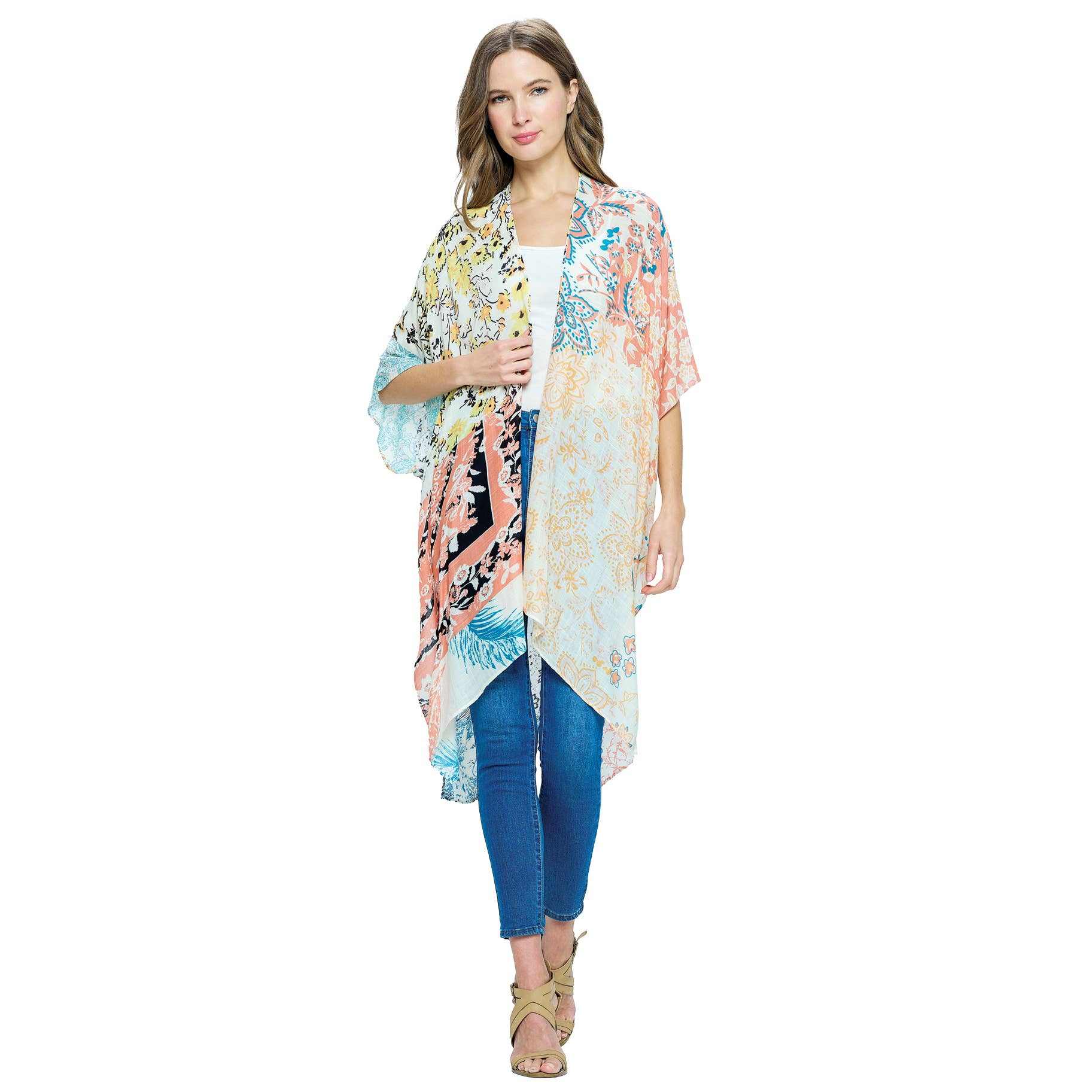 Woman wearing multi colored blush floral patterned kimono with open front and side slit over casual outfit