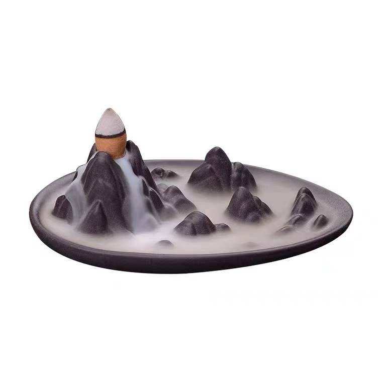 Ceramic Backflow Burner shaped like a mountain peak with cascading smoke effect on a round base