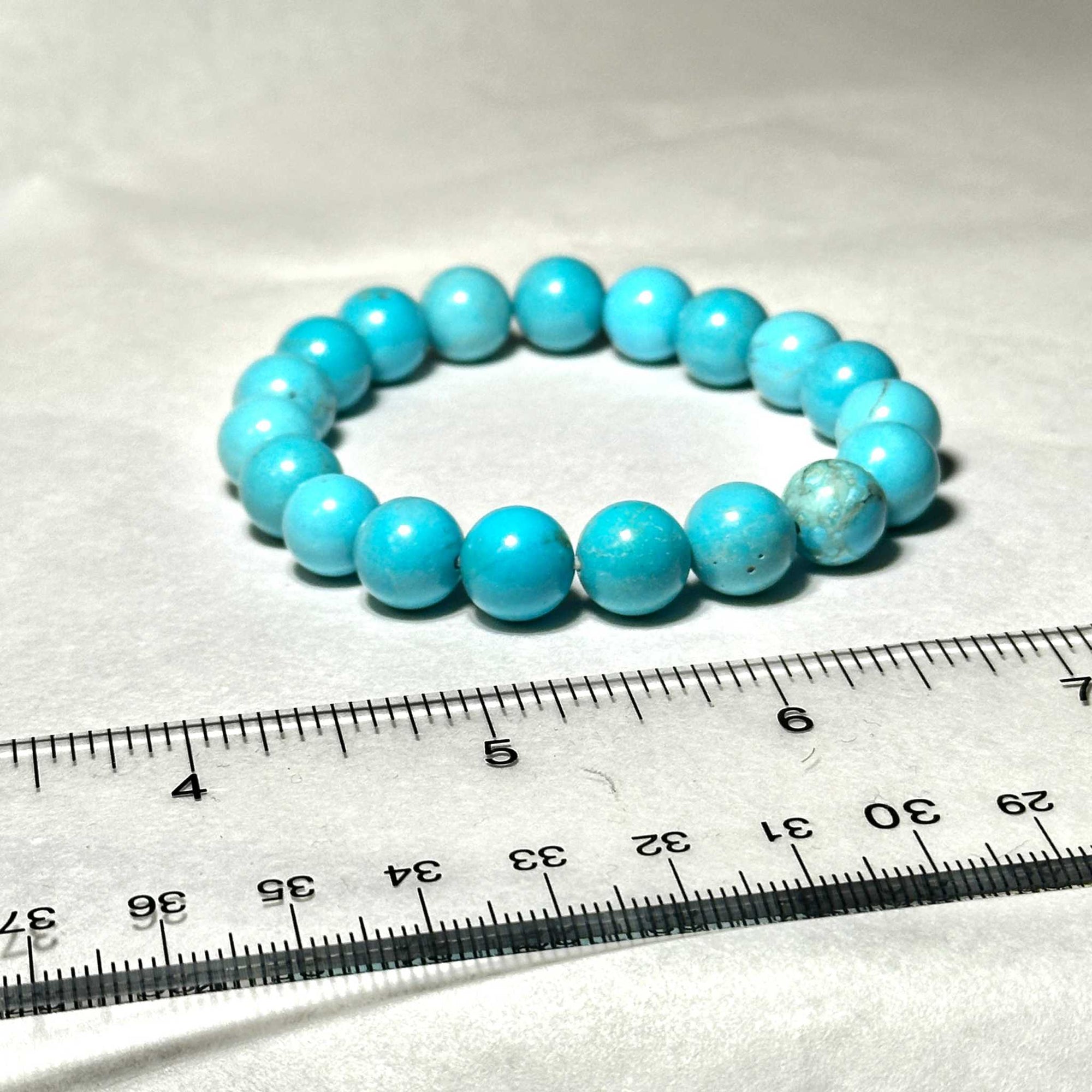 Blue Howlite natural crystal round bead stackable bracelet with vibrant sky-blue polished beads arranged in a circle.