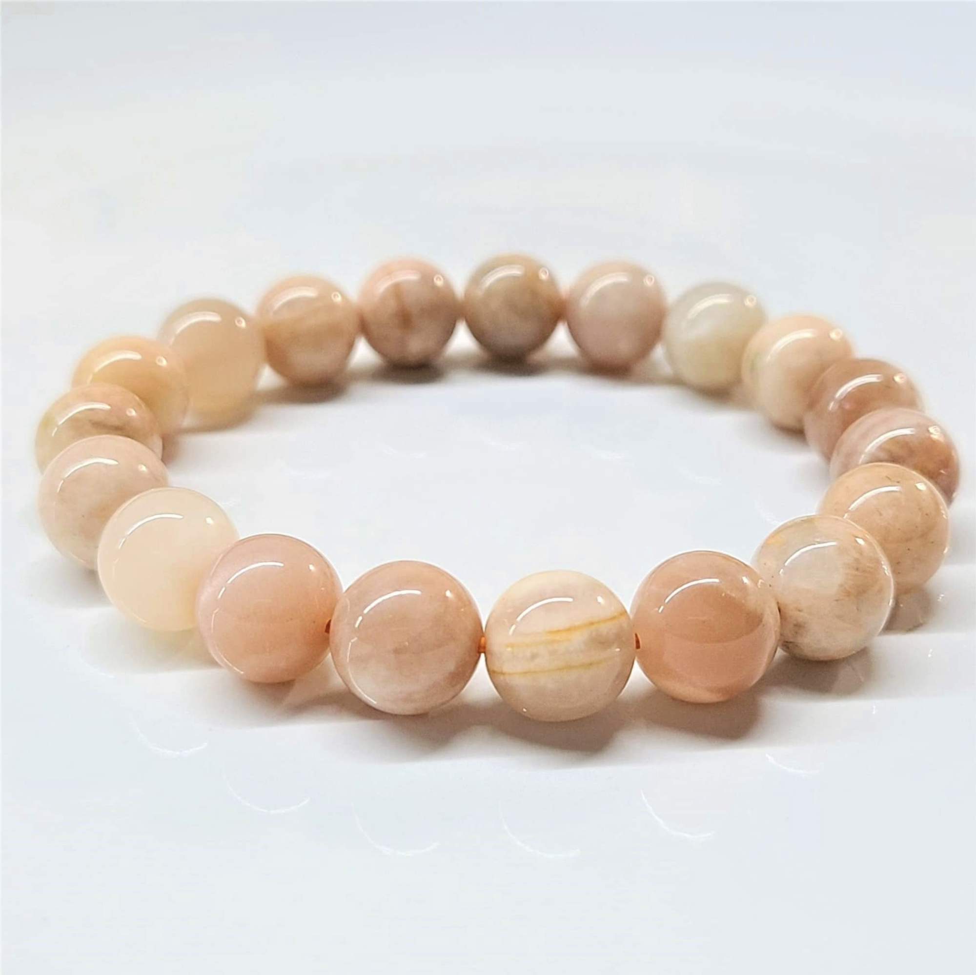 Peach Moonstone round bead stackable bracelet with soft milky glow and warm hues