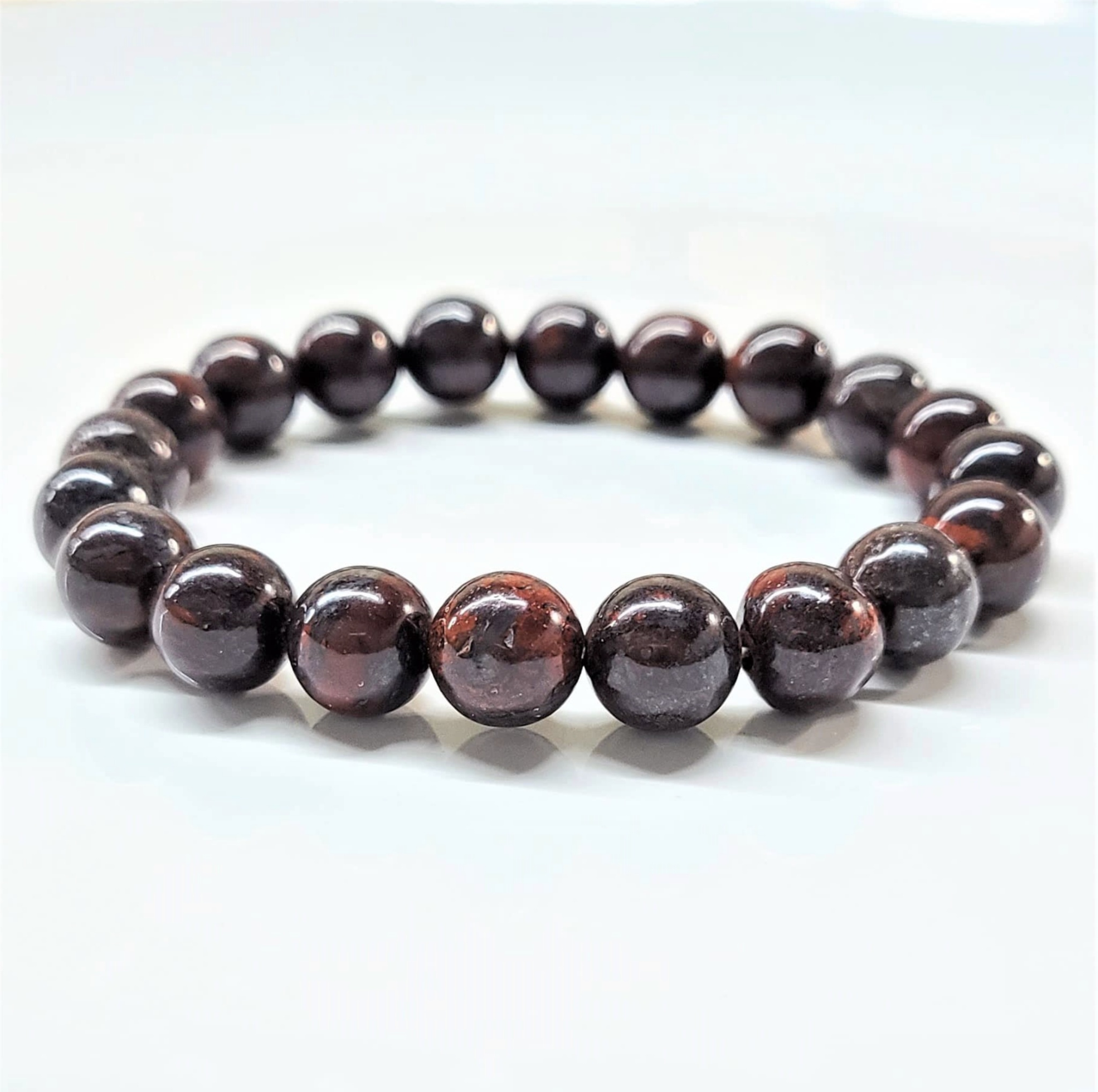 Bloodstone stackable round bead bracelet with deep green and red hues for courage and vitality.