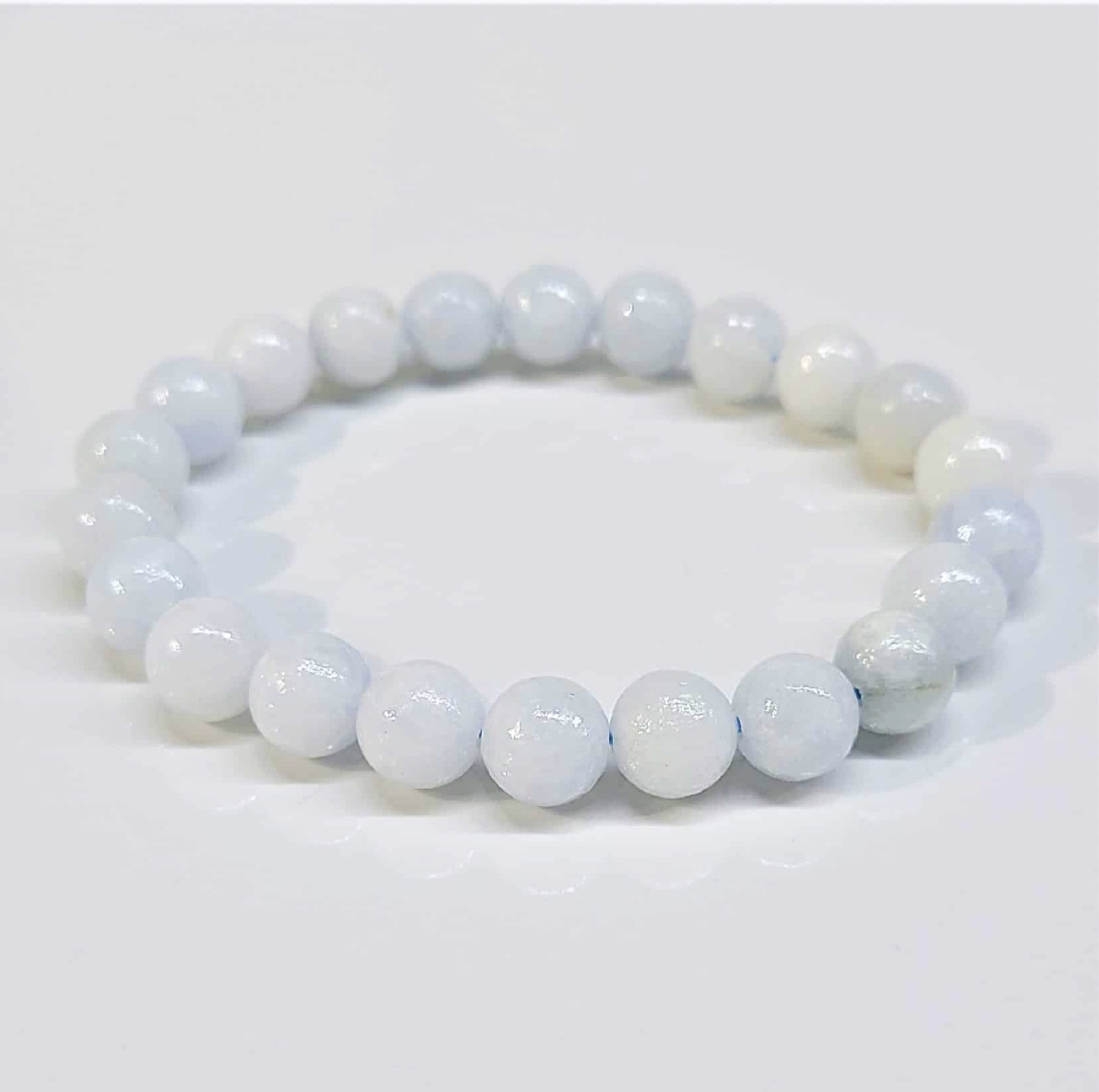 Celestite stackable round bead bracelet in soft blue and white tones, 8mm beads, promoting peace and spiritual clarity
