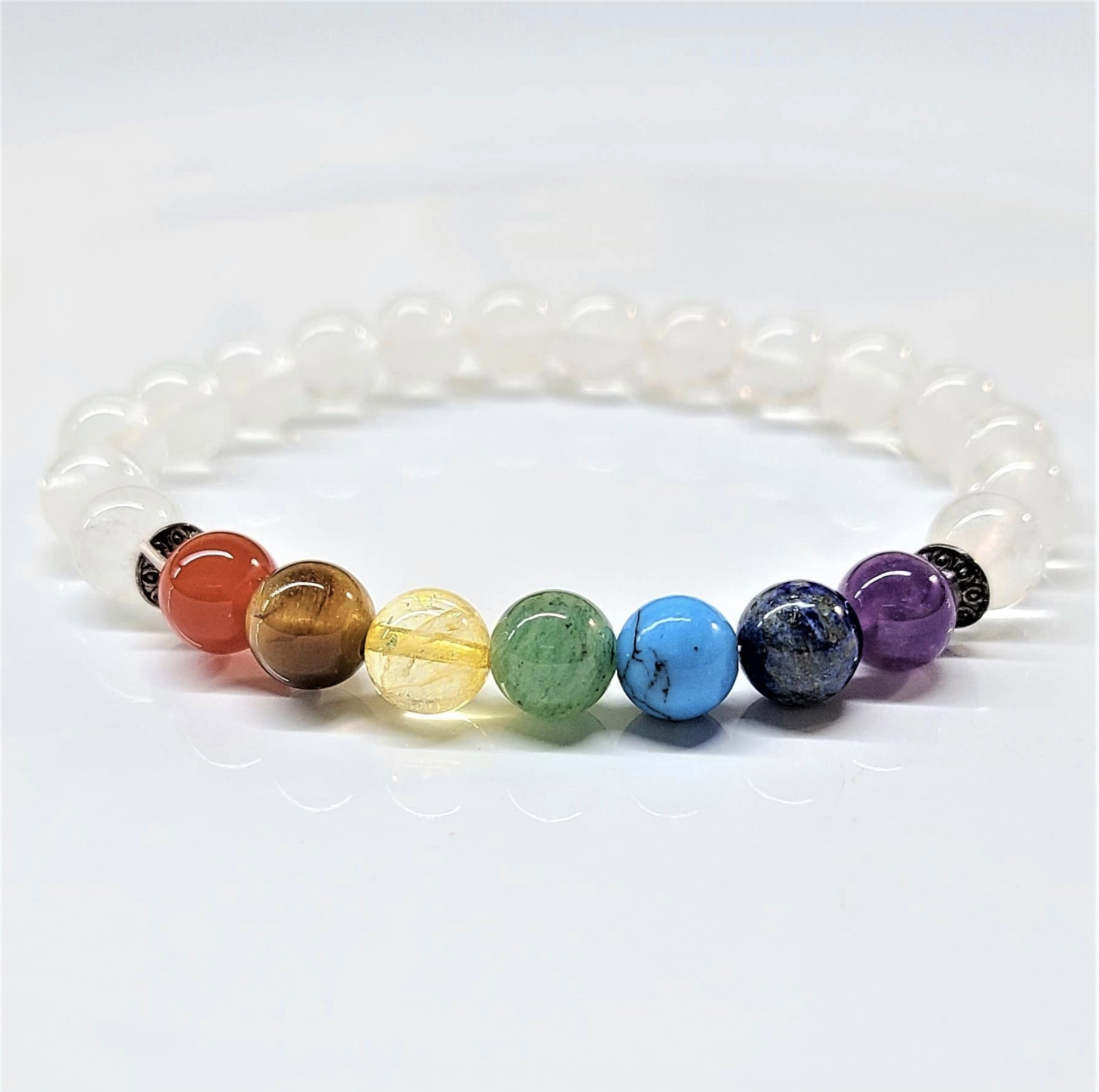 Clear Quartz Chakra Bracelet with 8mm round beads featuring seven colorful chakra stones and white quartz beads for energy balancing.