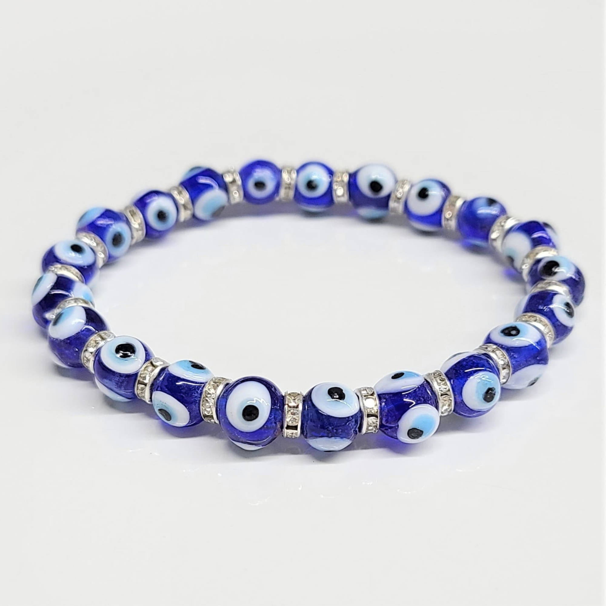 Blue evil eye round bead stackable bracelet with silver spacers for protection and negativity warding