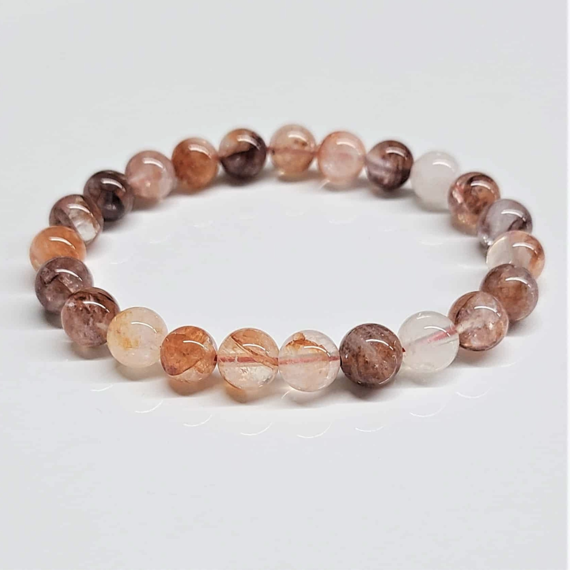 Fire Hematoid Quartz round bead bracelet with fiery red, orange, and brown inclusions for grounding and energy transformation.