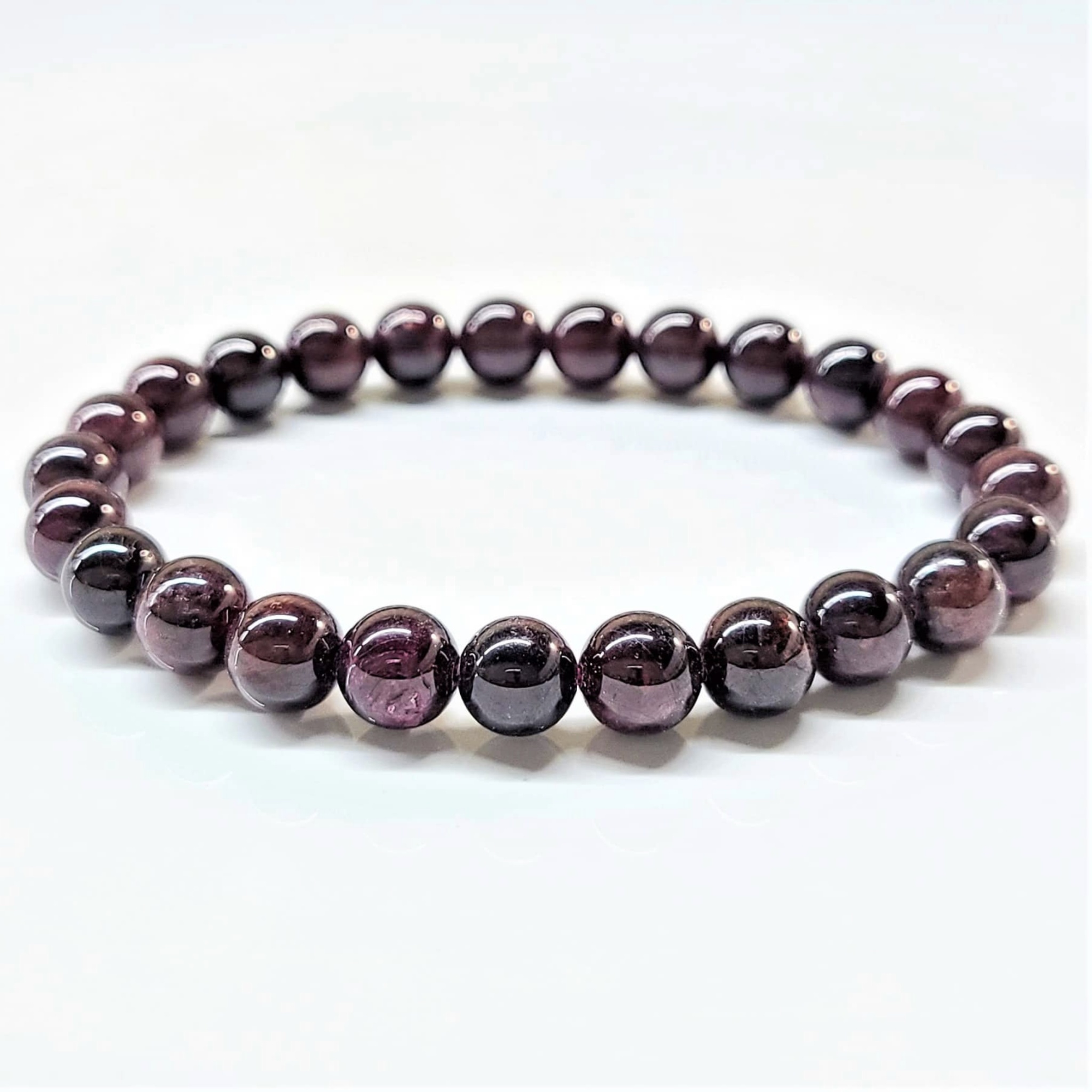 Garnet stackable bracelet with polished round deep red beads on elastic band