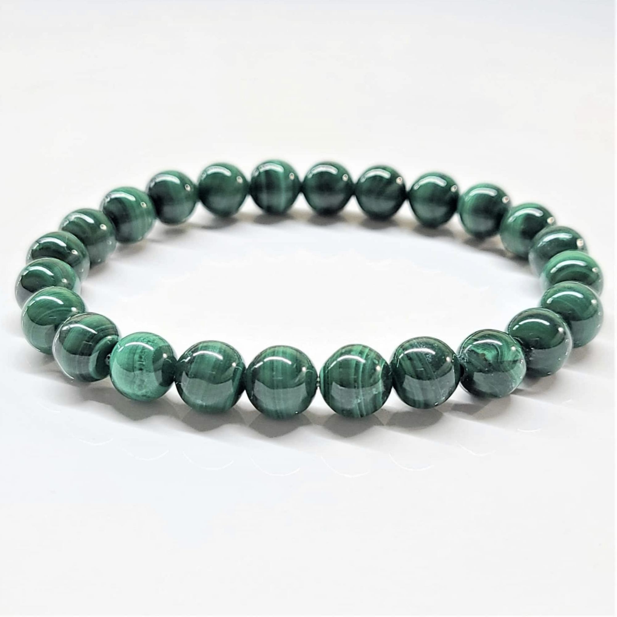 Natural Malachite stackable bracelet with polished green gemstone beads showing characteristic banding patterns