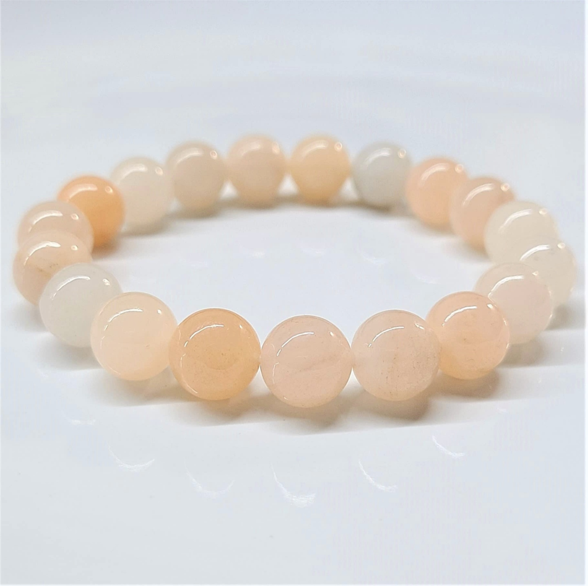 Pink Aventurine round bead stackable bracelet with soft pink hues and a smooth polished finish.