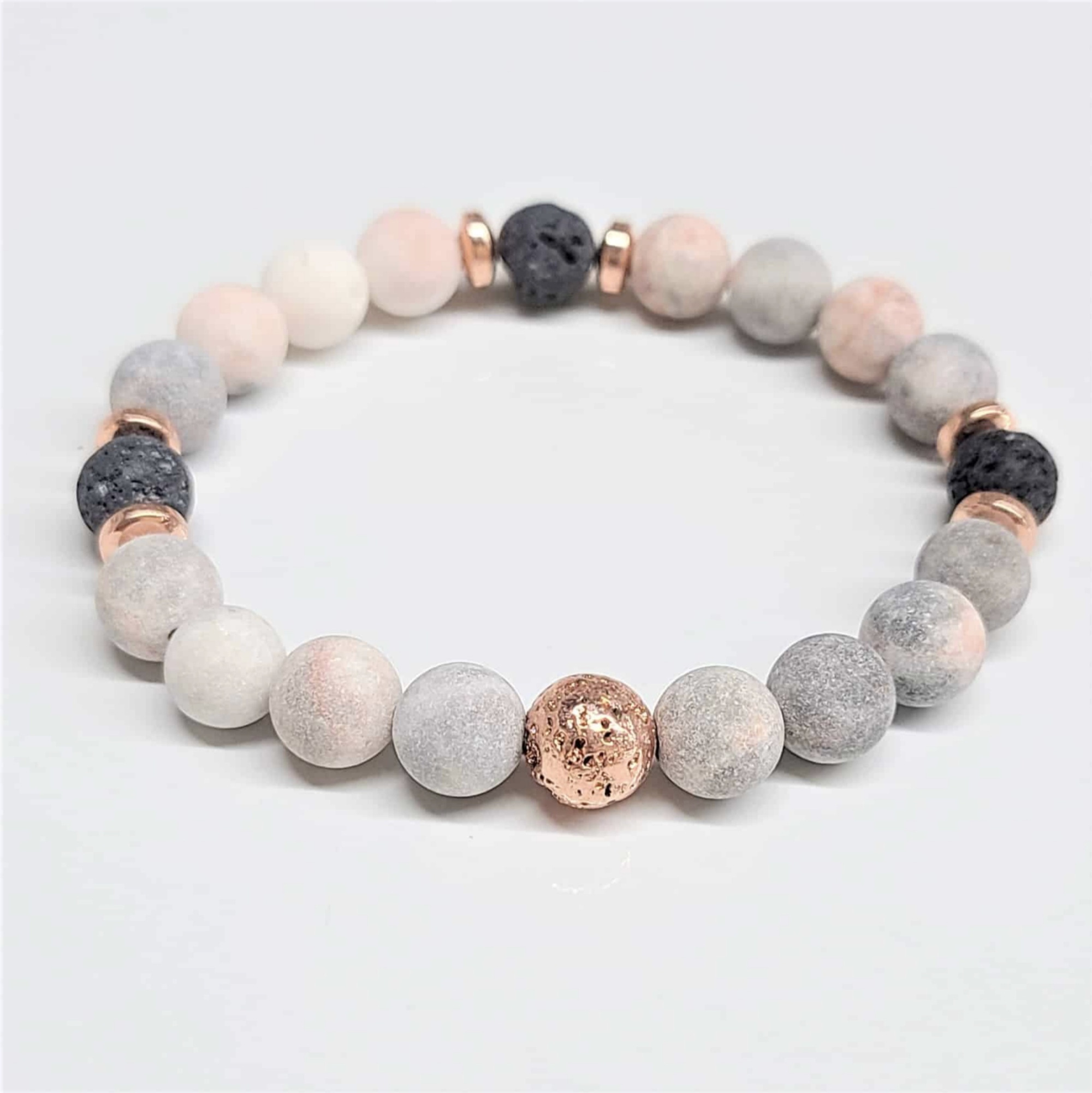 Pink Zebra Jasper stackable bracelet with 8mm round beads and lava stone accents for grounding and emotional balance