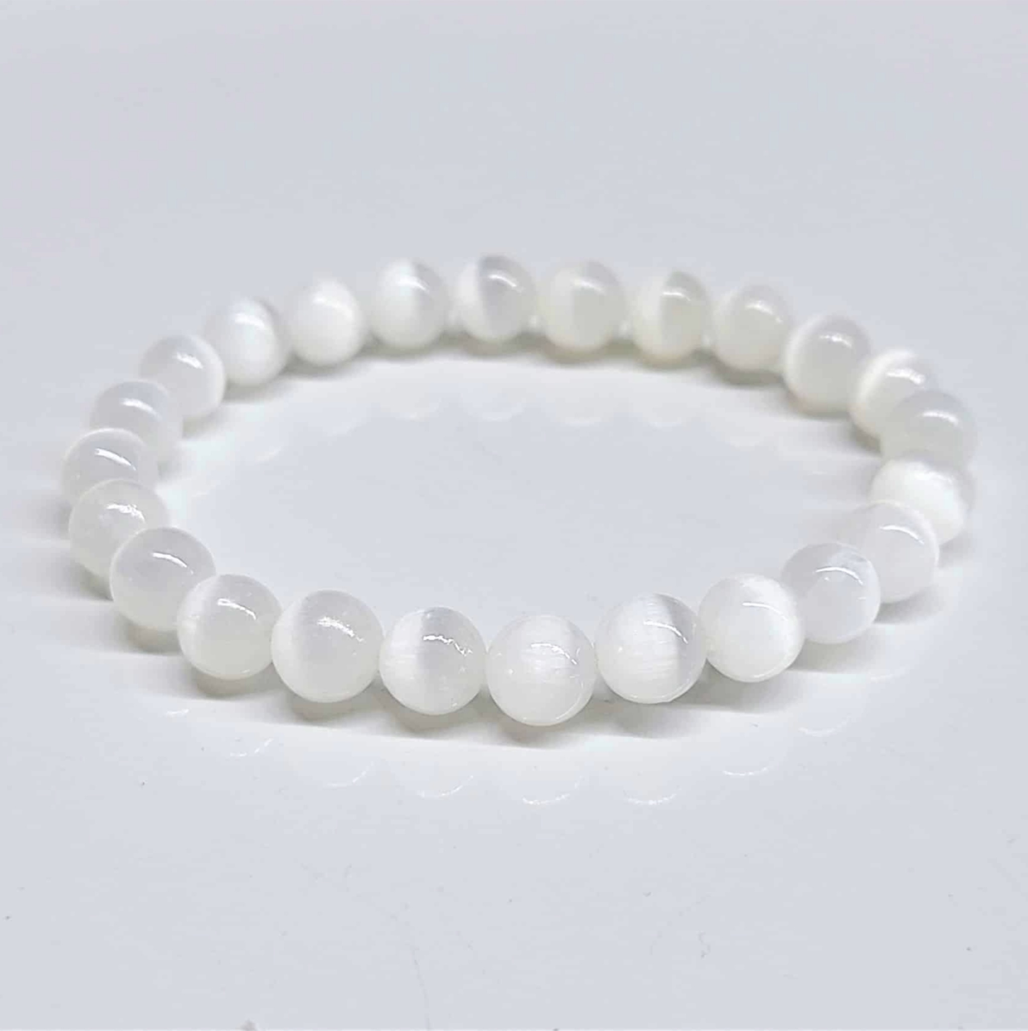 Selenite stackable bracelet with smooth 8mm round beads for aura cleansing and spiritual energy.