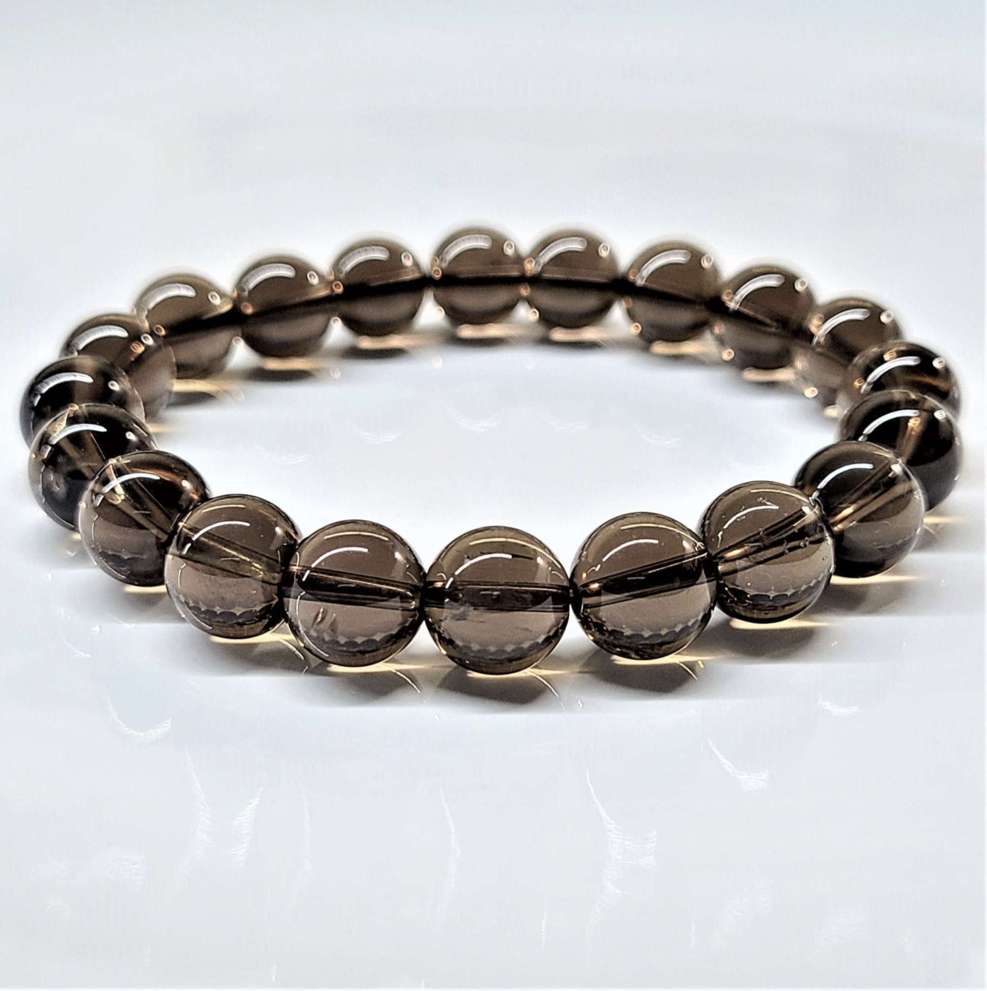 Smokey Quartz round bead stretch bracelet with translucent brown beads for grounding and protection.