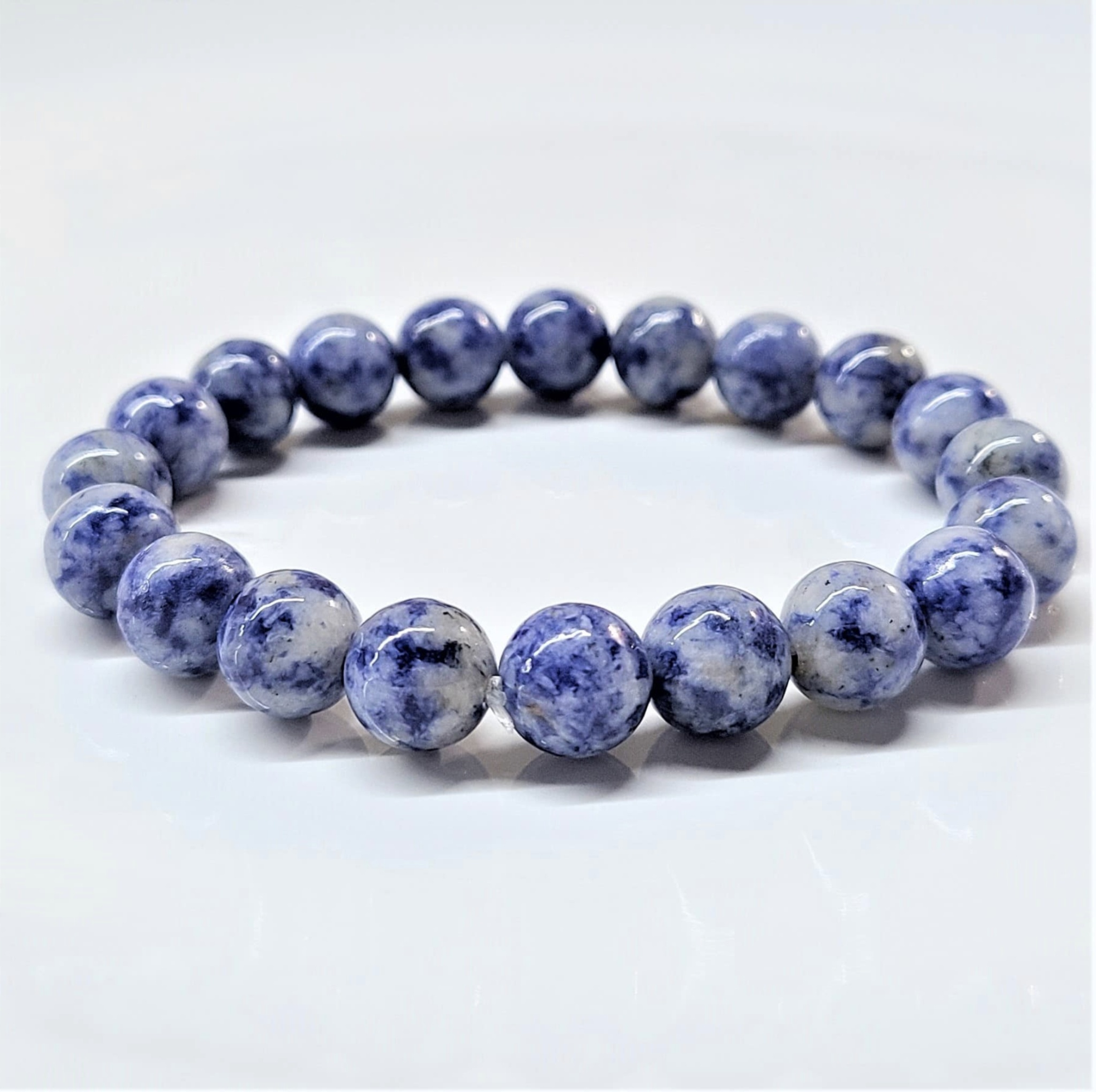Sodalite stackable bracelet with round deep blue and white veined beads for clarity and emotional balance