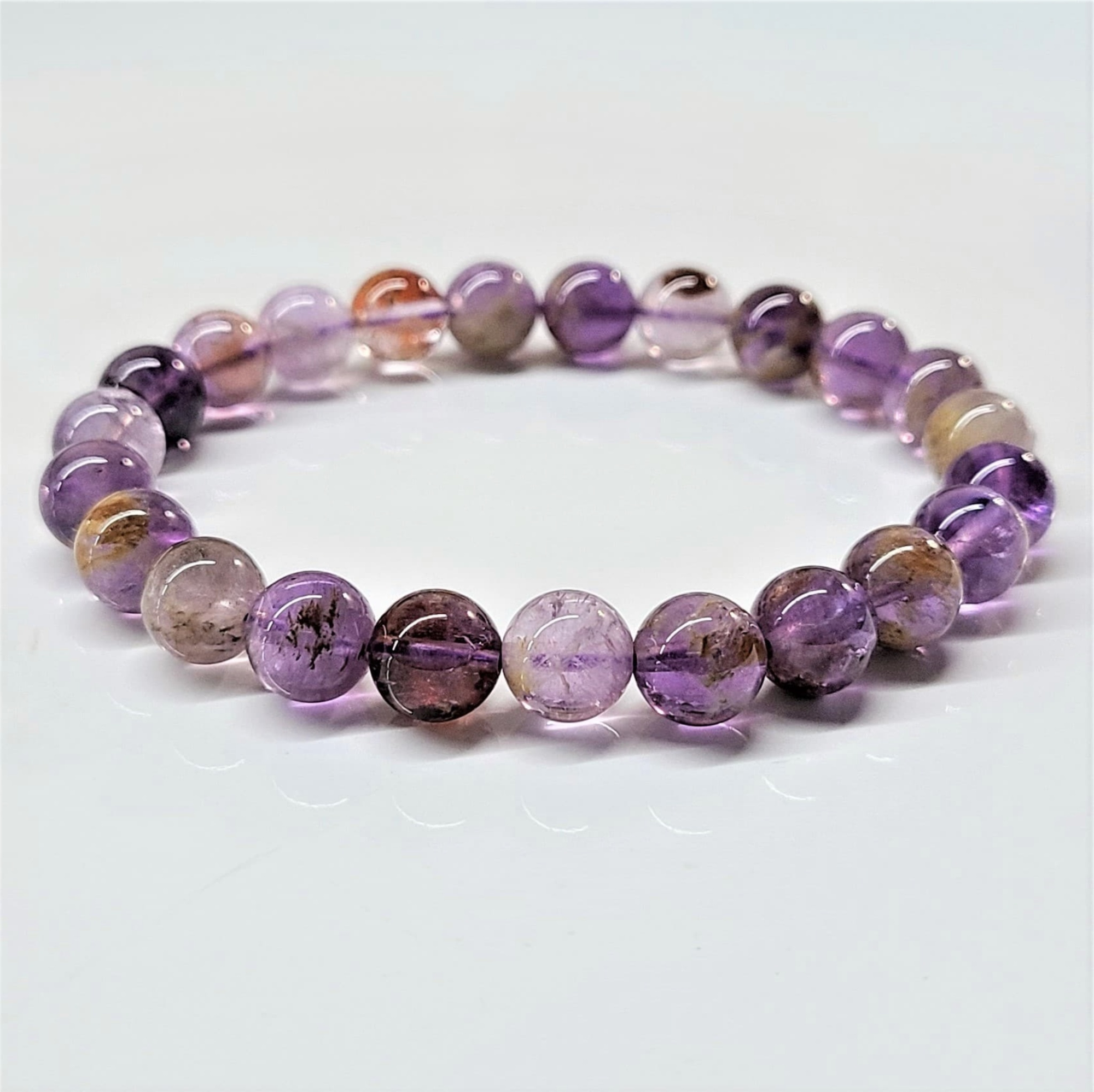 Super 7 stackable bracelet with round purple and brown natural crystal beads on stretch band