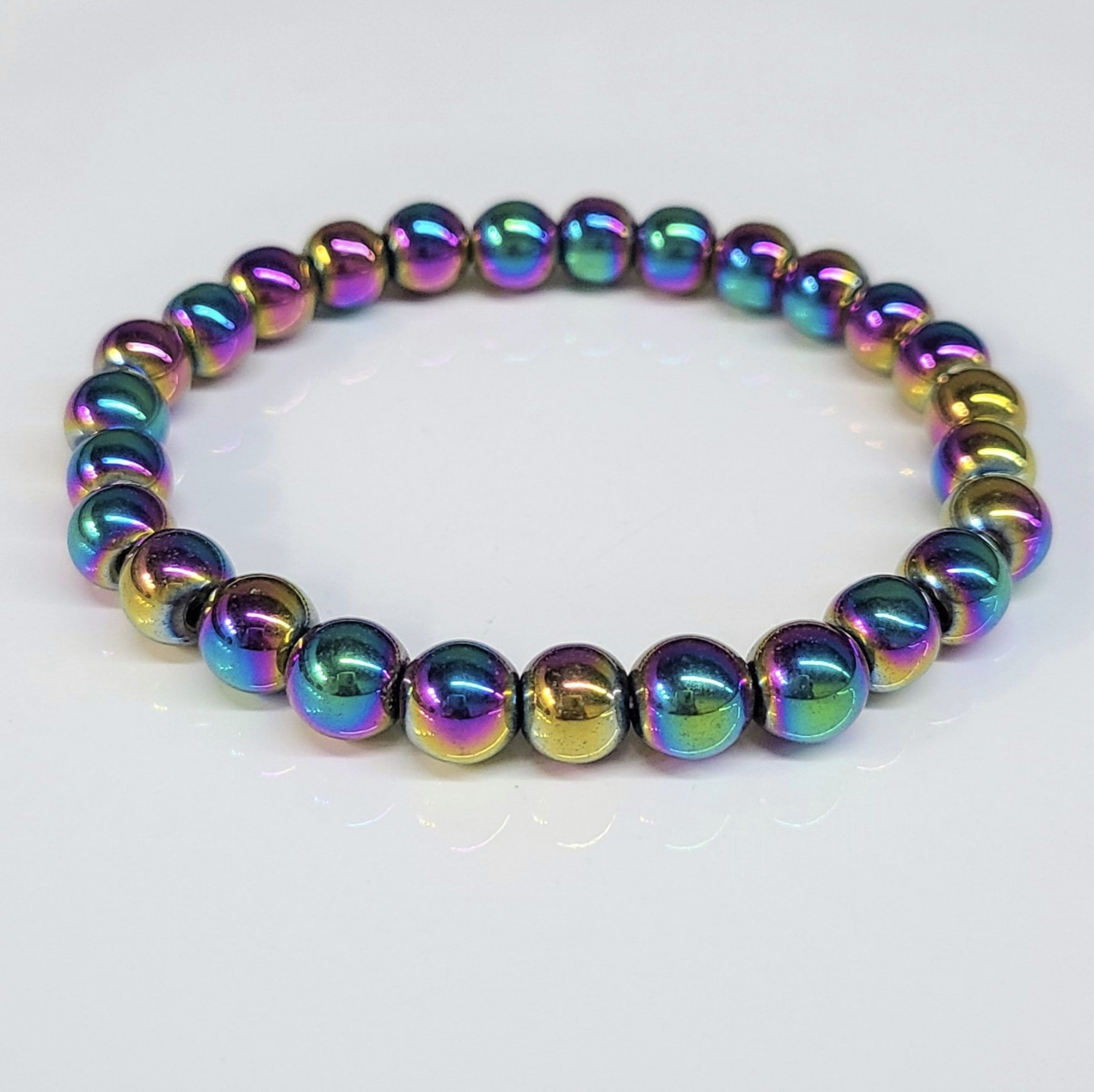 Colorful titanium hematite round bead bracelet with metallic rainbow finish, 8mm beads, stackable design for energetic shielding and grounding.