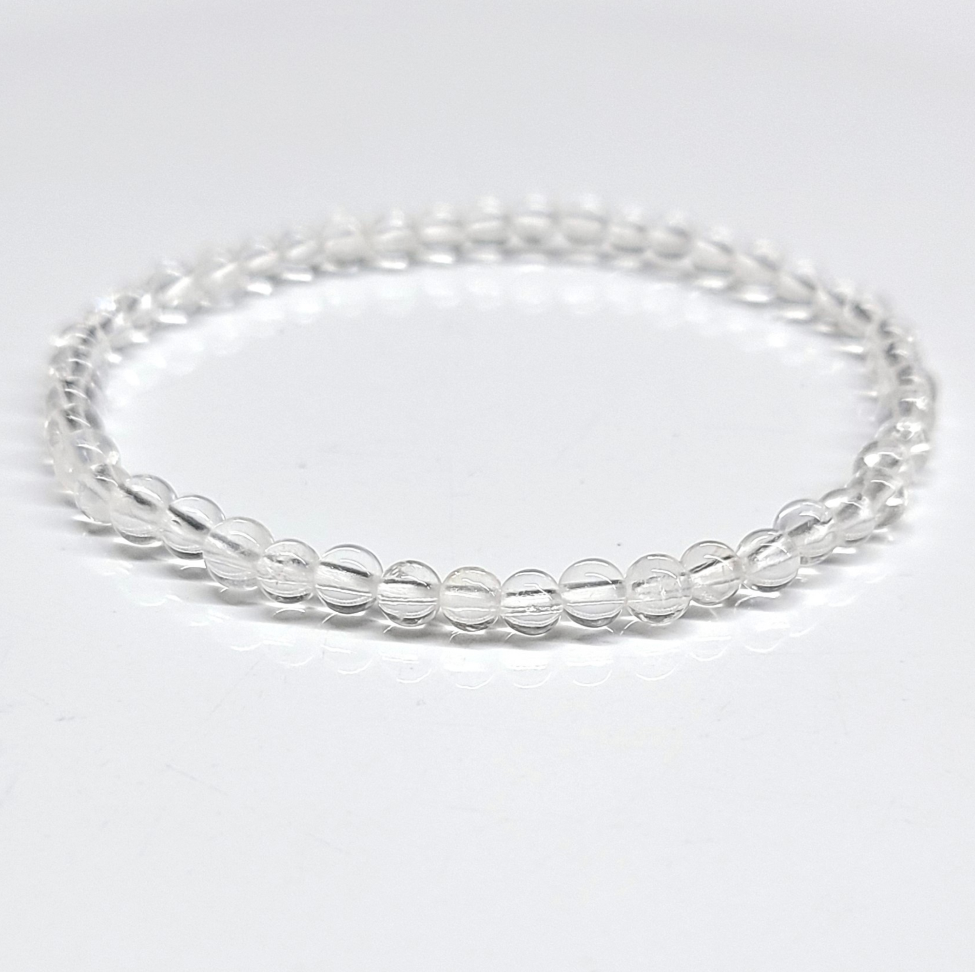 Clear Quartz Bracelet 4mm with translucent beads for energy amplification and spiritual awareness.