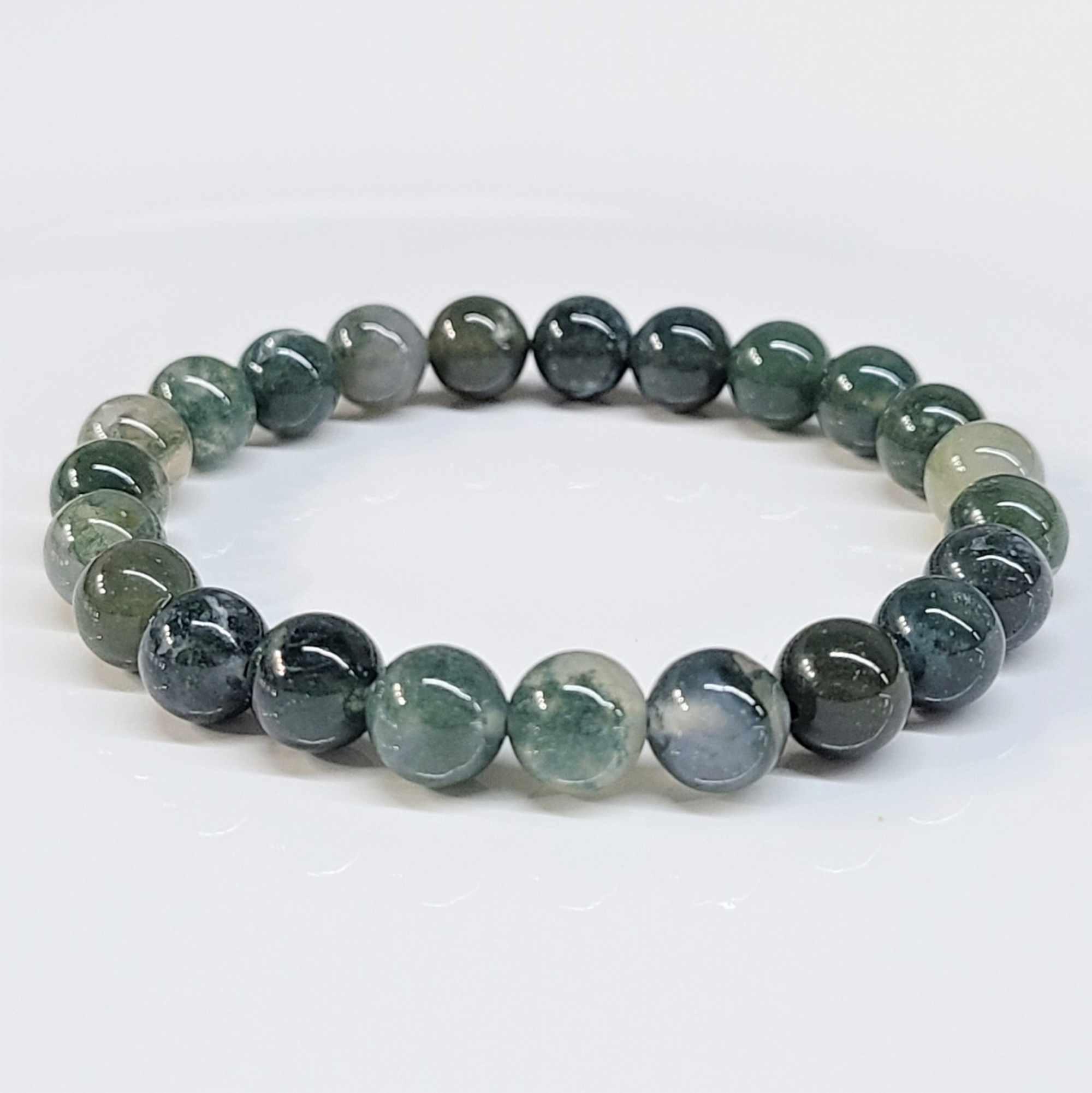 Moss Agate round bead stackable bracelet with natural green and earthy tones, symbolizing nature renewal and grounding energy.