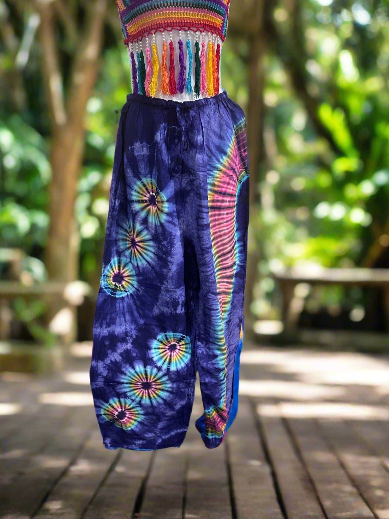 Rayon Tie-Dye Straight Leg Pants with vibrant bohemian pattern on a wooden outdoor path.