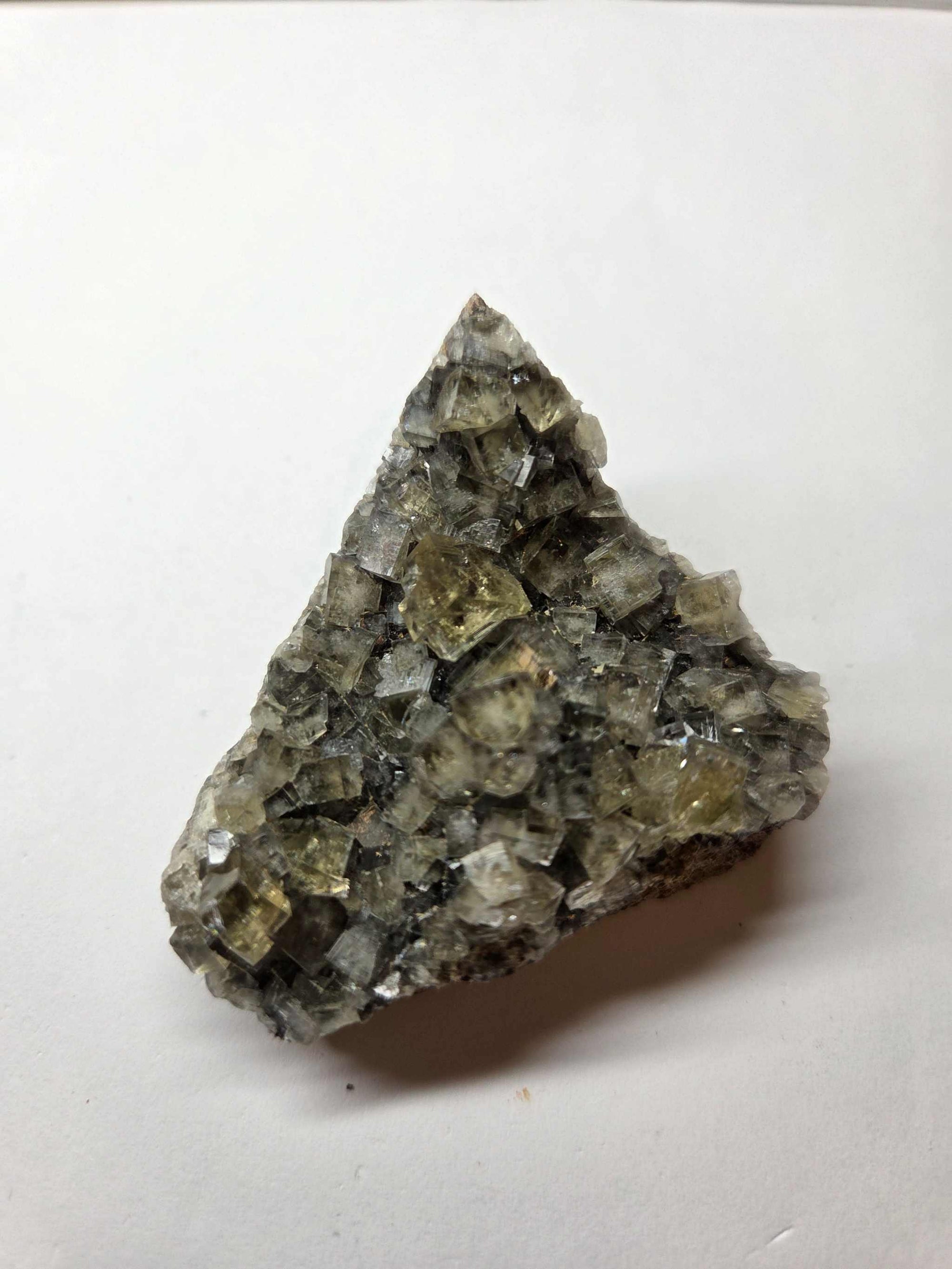Yellow Fluorite crystal specimen with translucent yellow and gray cubic formations on a white background