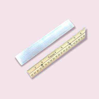Selenite Chakra Engraved Charging Altar with ruler for size reference.