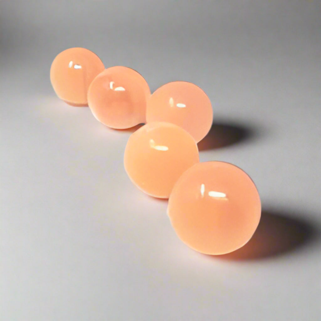 peach selenite spheres on a white background