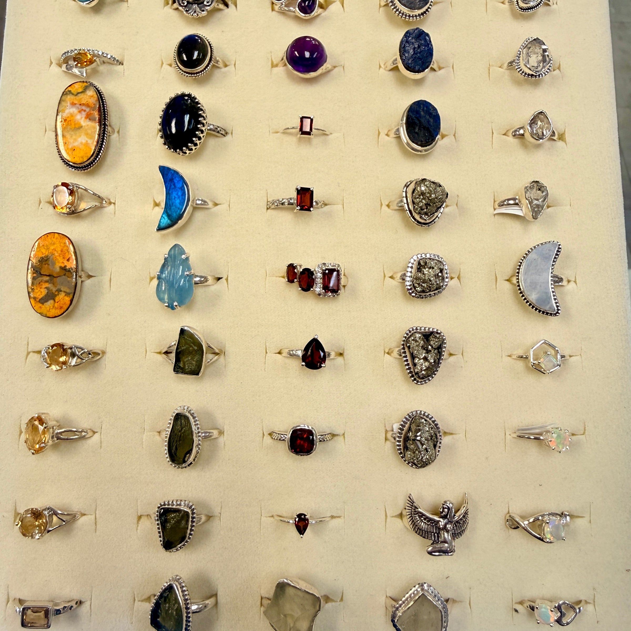 A tray of sterling silver rings with gemstones. 
