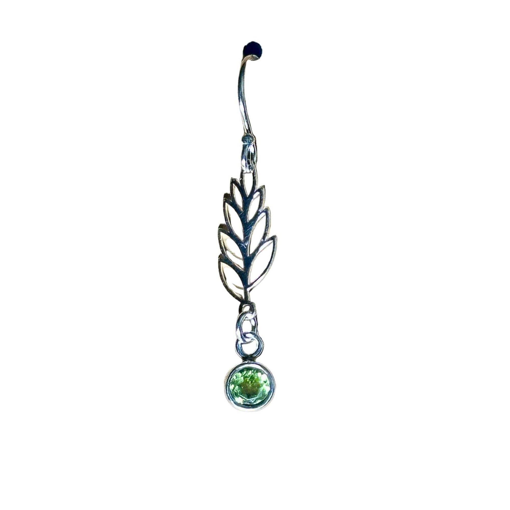 Silver earring with leaf design and green Peridot gemstone on white background
