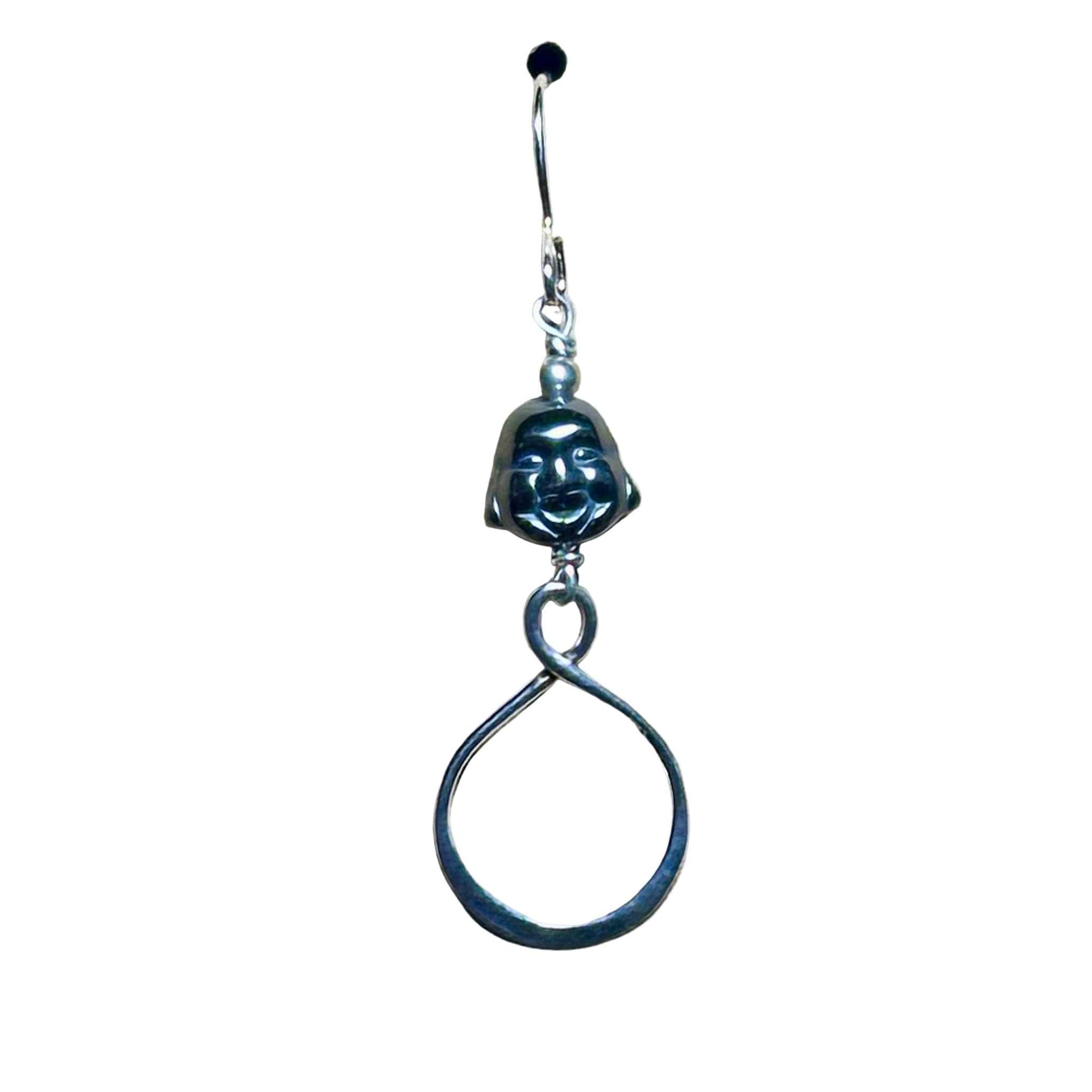 Sterling silver earring with circular infinity design with Hematite Buddha head bead on a white background
