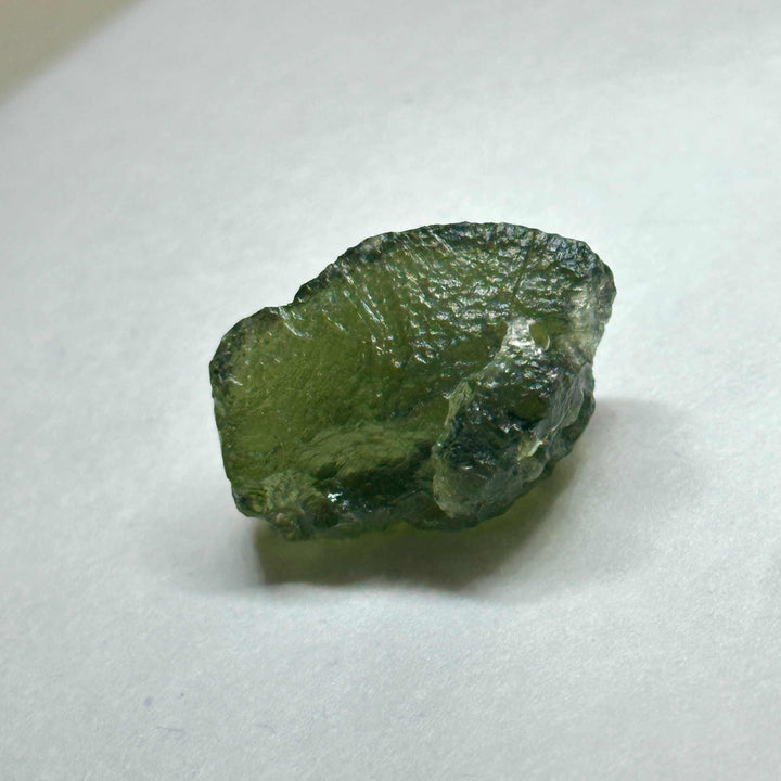 Raw Moldavite tektite stone weighing 4.64 grams with deep green texture for spiritual and cosmic development.