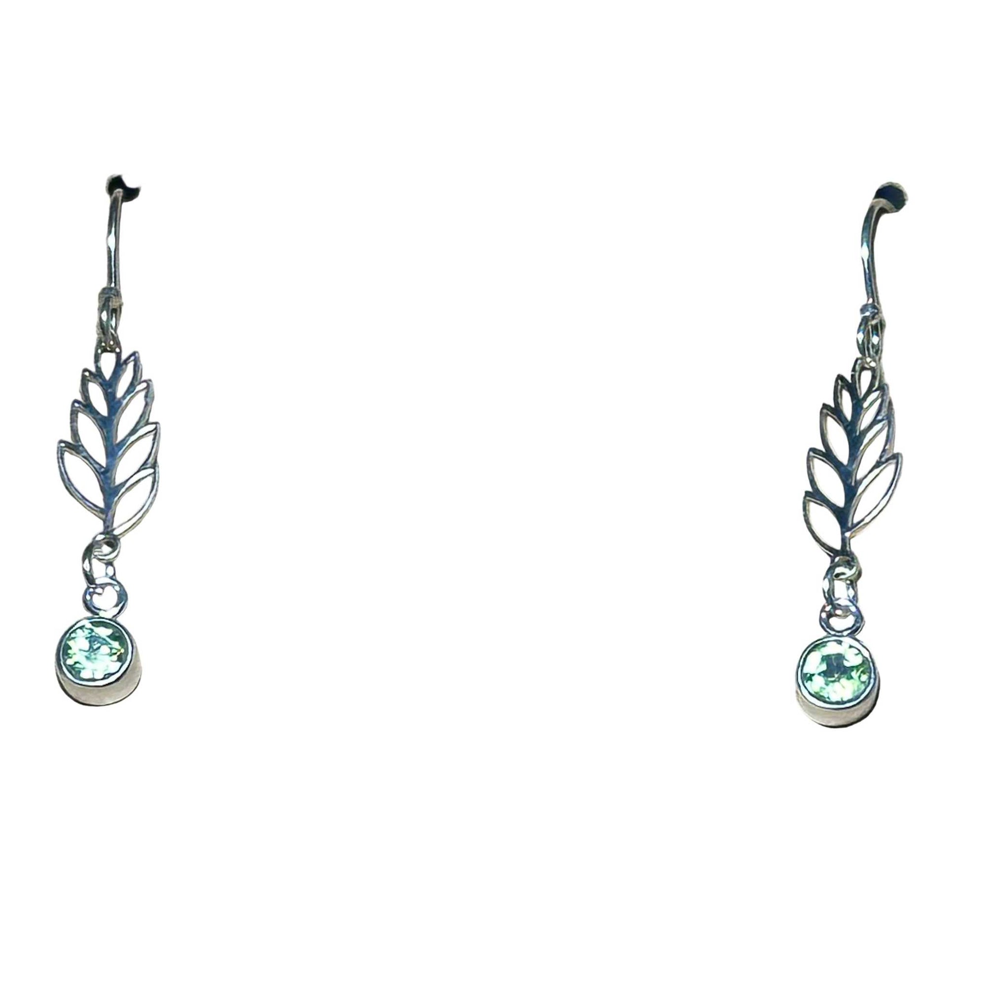 Silver leaf-shaped earrings with green Peridot gemstones on a white background