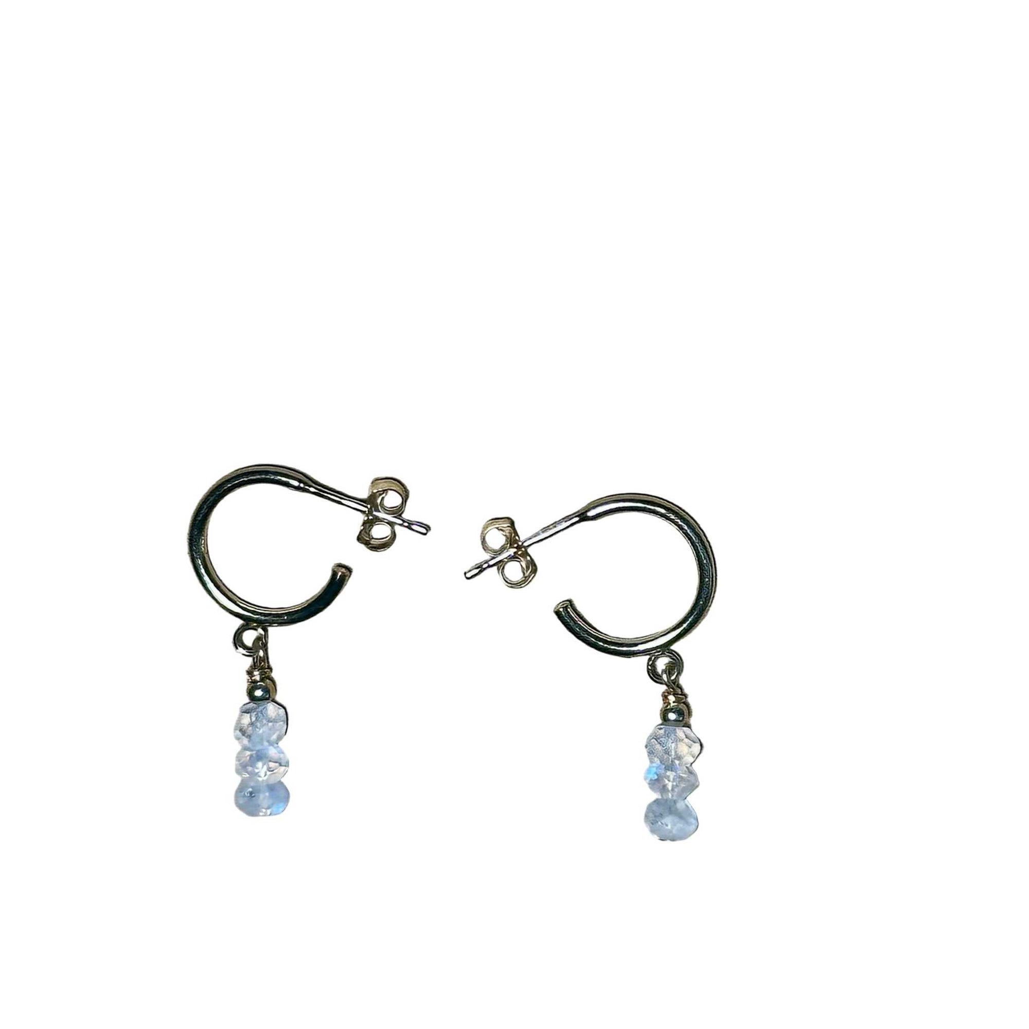 Pair of gold hoop earrings with Rainbow Moonstone gemstone faceted beads on a background