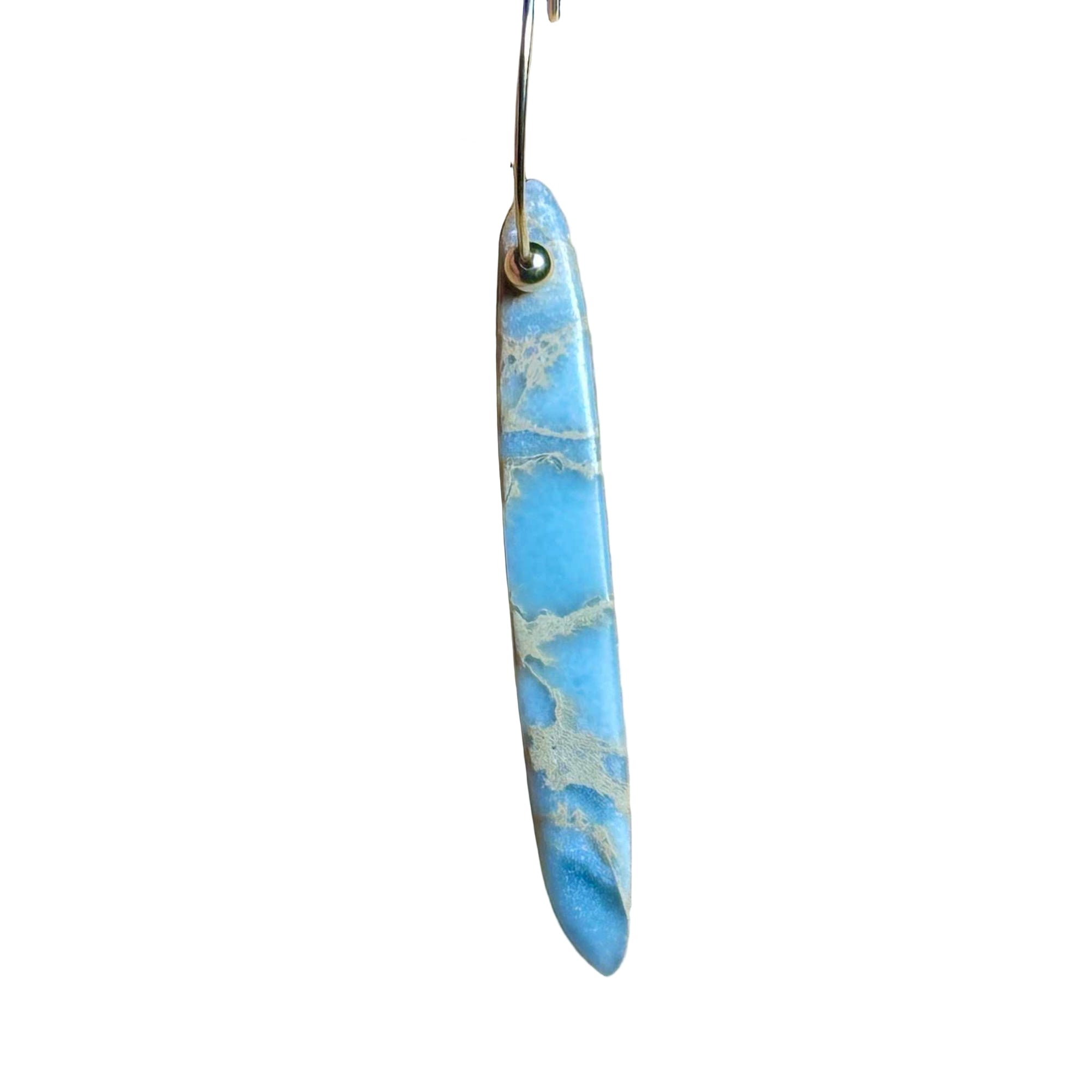 Gold Hoop earrings with blue marbled African Opal stone pendant on a background