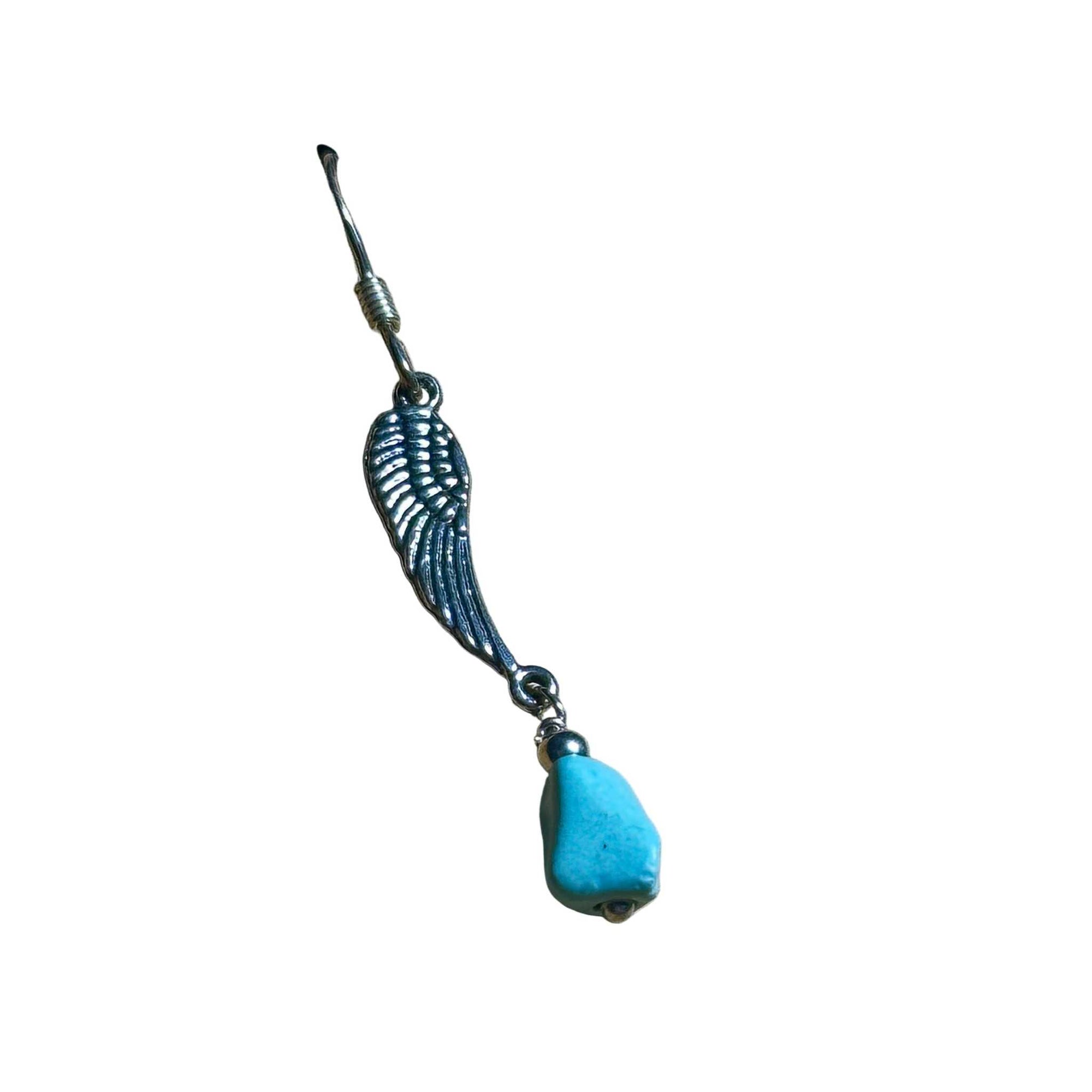 Sterling Silver earring with wing design and natural turquoise bead on a background
