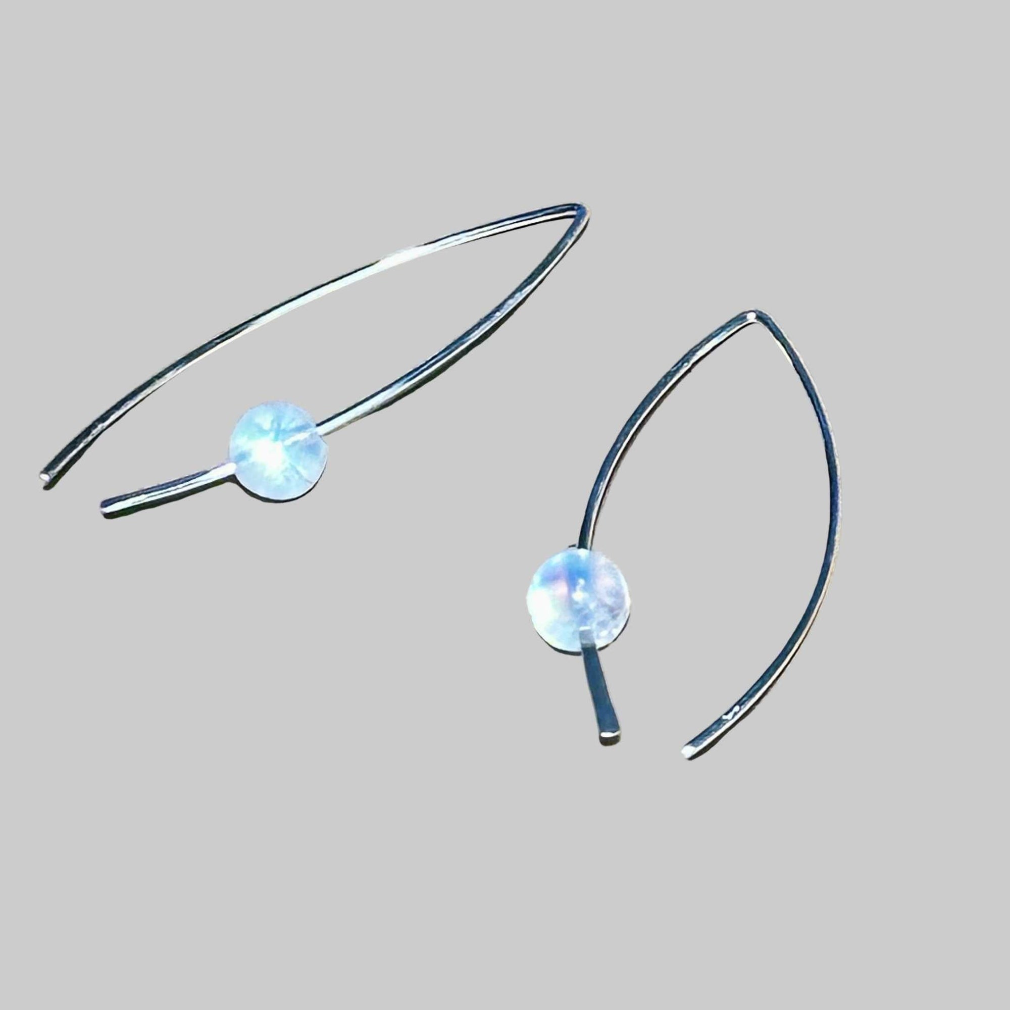 Sterling silver crescent earrings with genuine rainbow moonstone featuring iridescent flashes, lightweight and handcrafted.