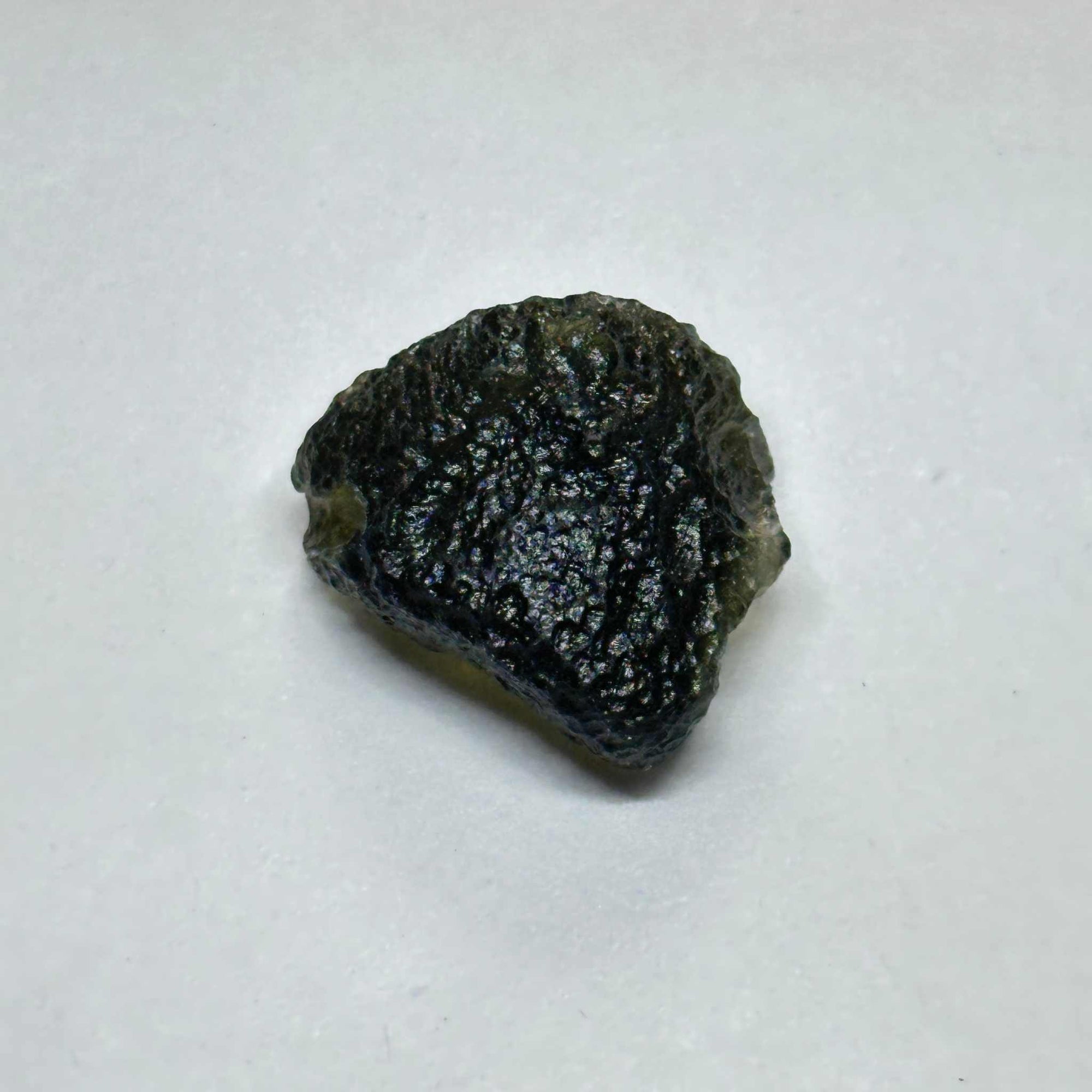 Moldavite tektite stone weighing 3.990 grams with rough textured surface, rare cosmic spiritual crystal from Czech Republic