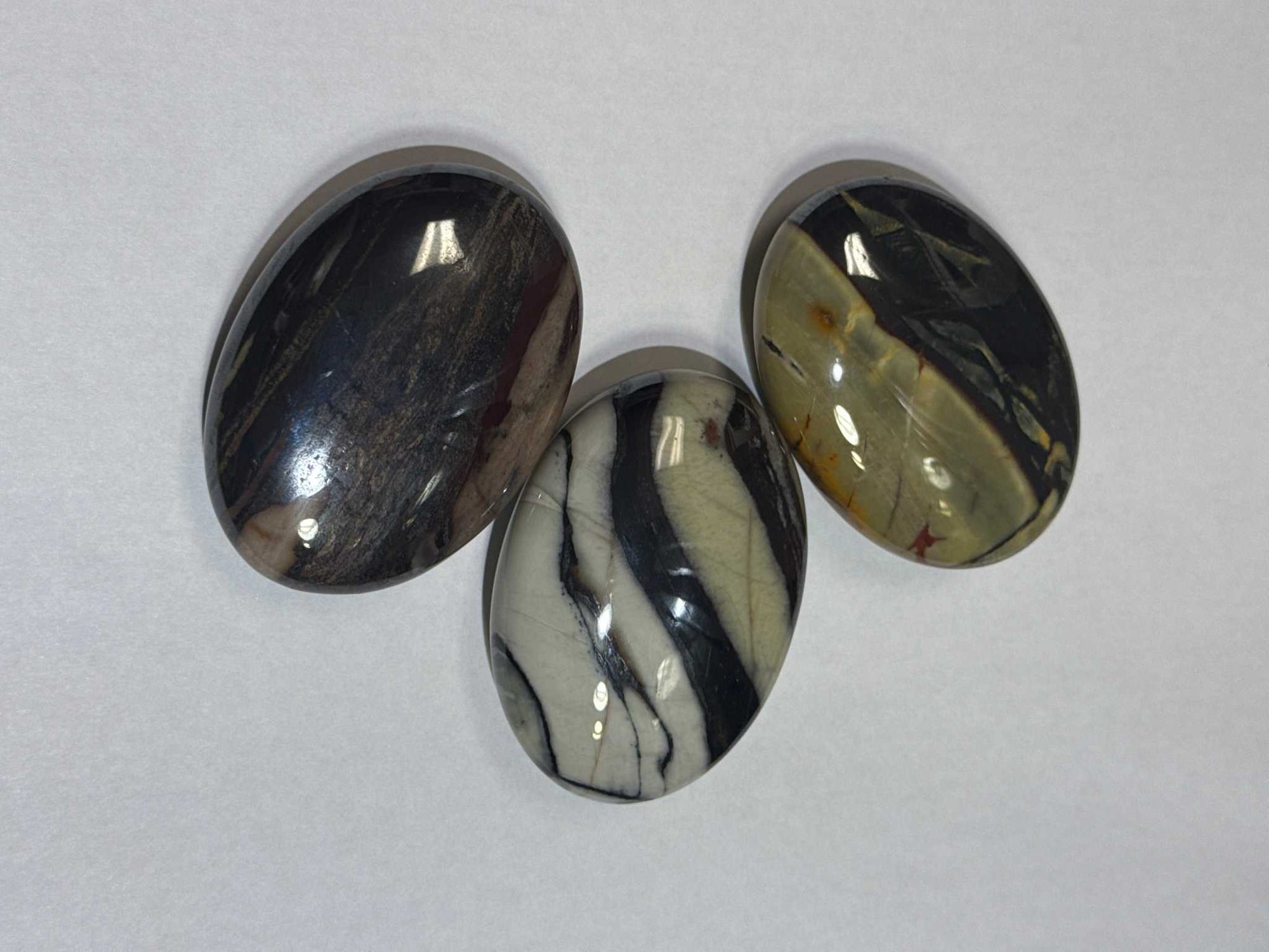 Three marbled stones on a white background