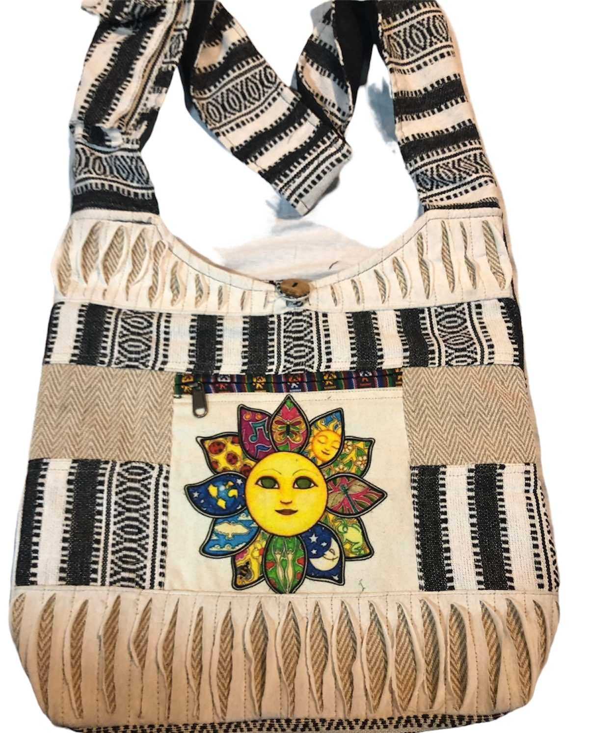 Sun Face Shoulder Bag with colorful sun motif and black and white patterned fabric, featuring a wide shoulder strap and spacious interior.