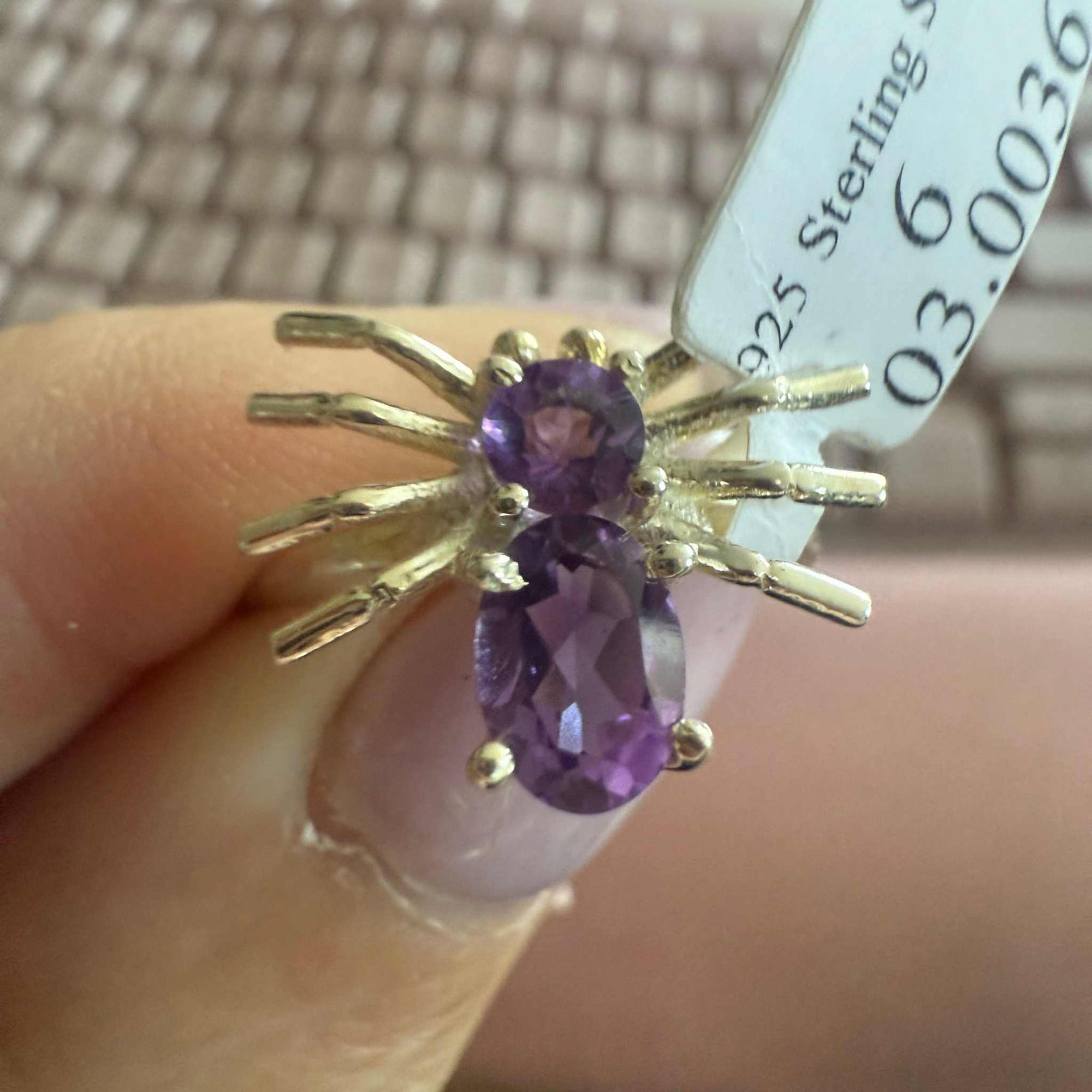 Spider ring with precious metal band and spider legs with gemstone spider body