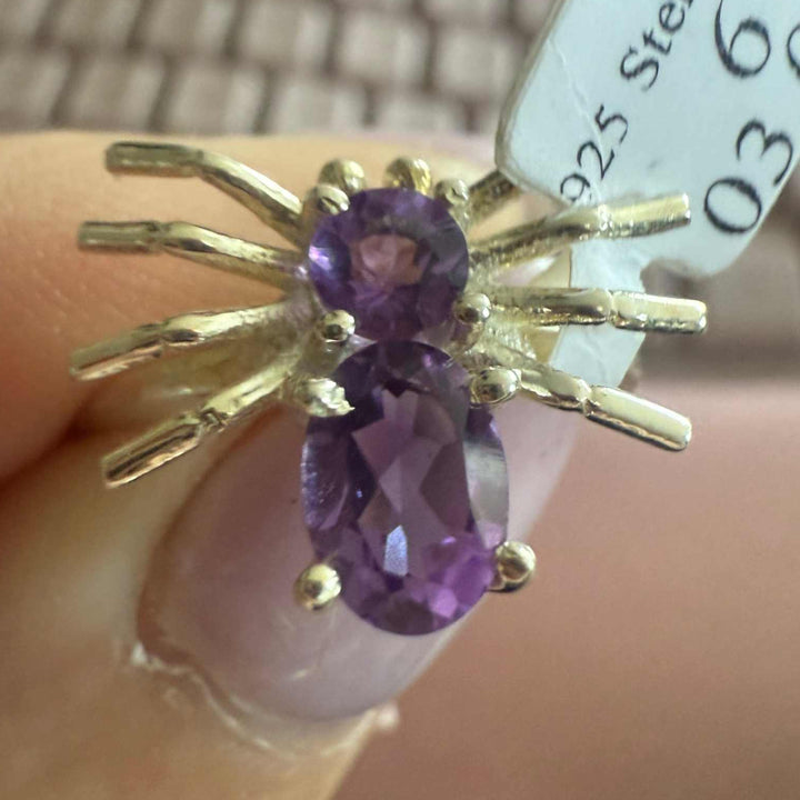 Spider ring with precious metal band and spider legs with gemstone spider body