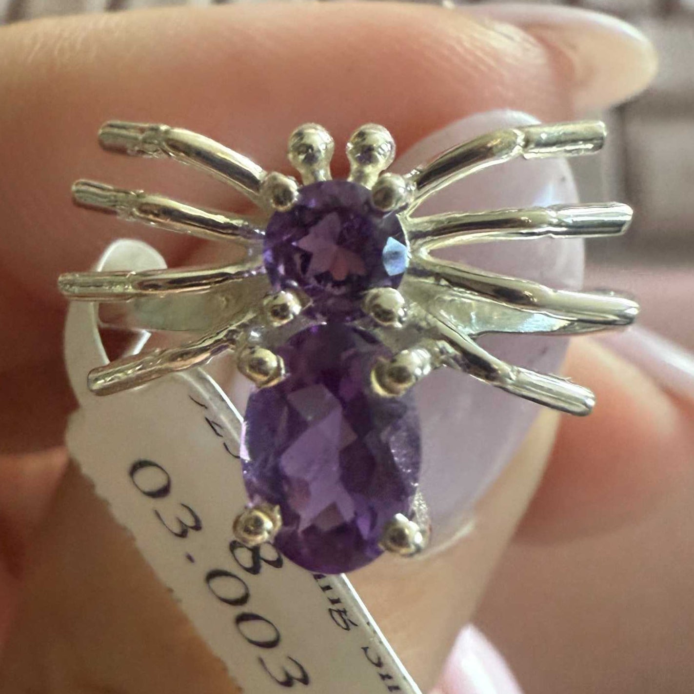 Spider ring with precious metal band and spider legs with gemstone spider body