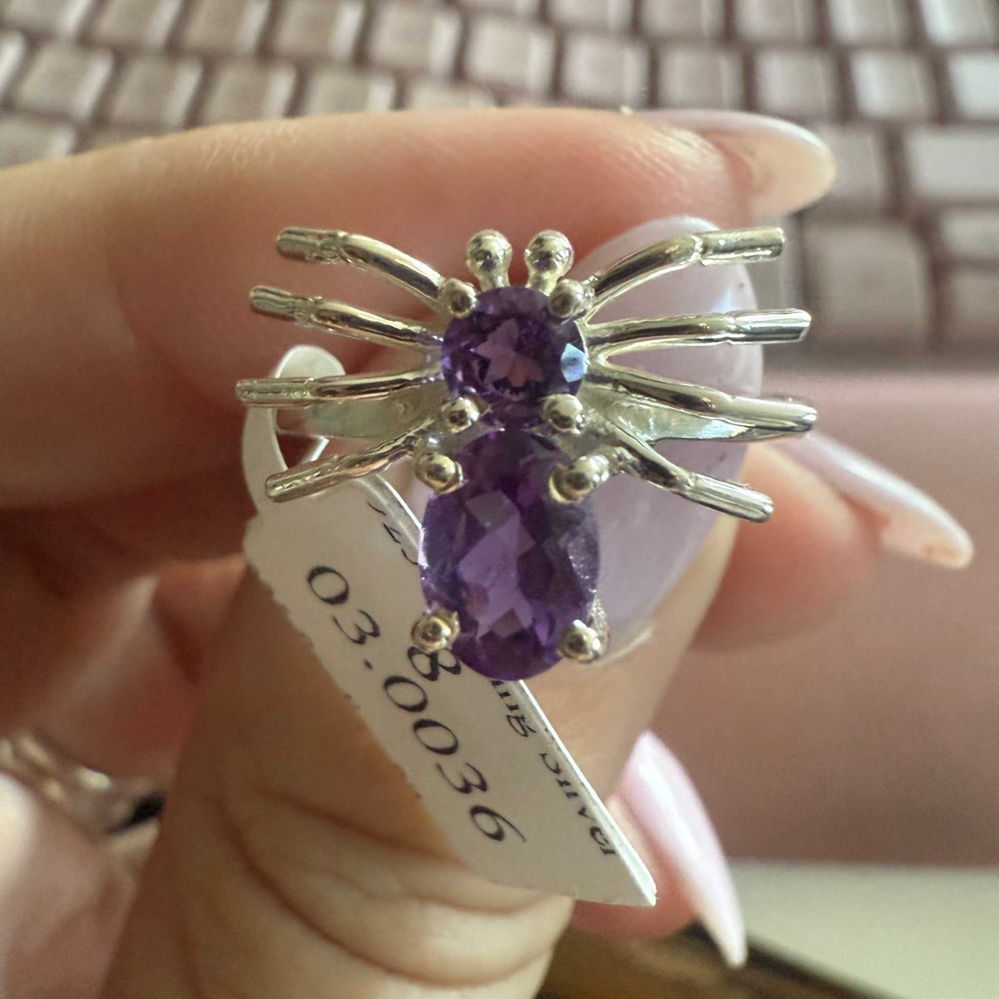 Spider ring with precious metal band and spider legs with gemstone spider body