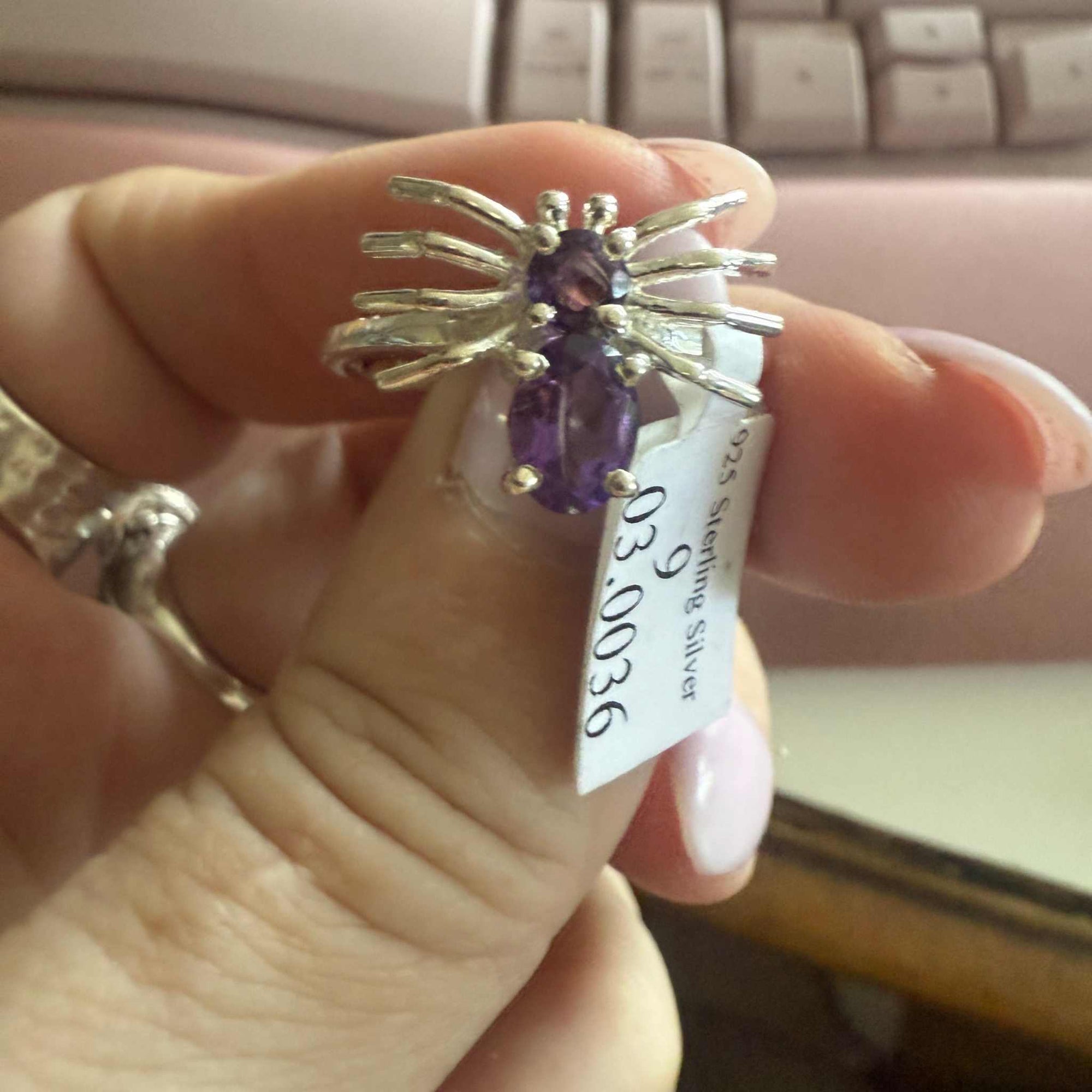 Spider ring with precious metal band and spider legs with gemstone spider body