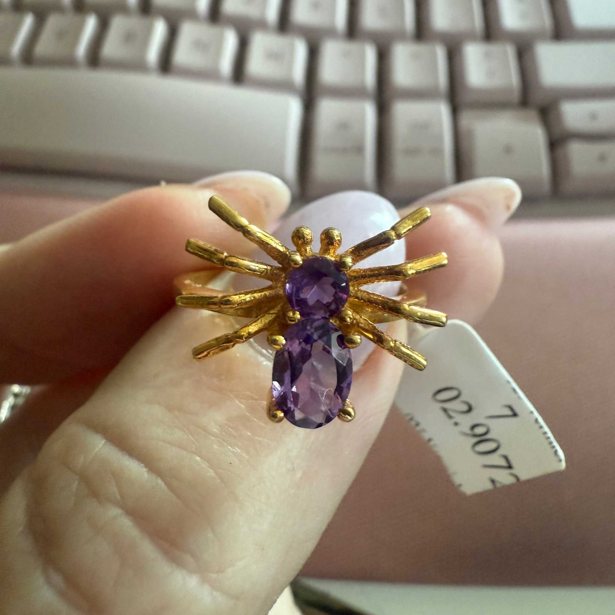 Spider ring with precious metal band and spider legs with gemstone spider body
