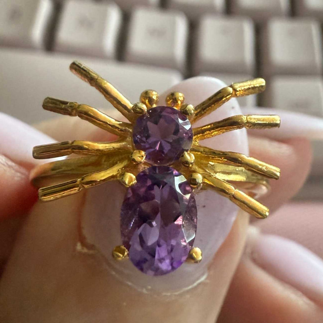 Spider ring with precious metal band and spider legs with gemstone spider body