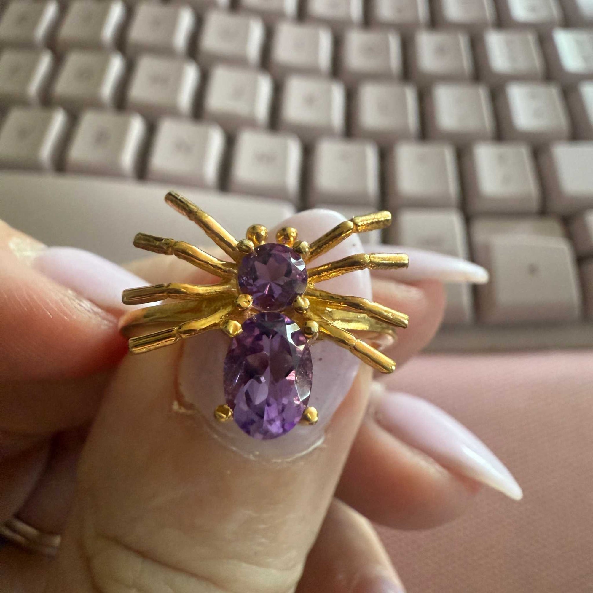 Spider ring with precious metal band and spider legs with gemstone spider body