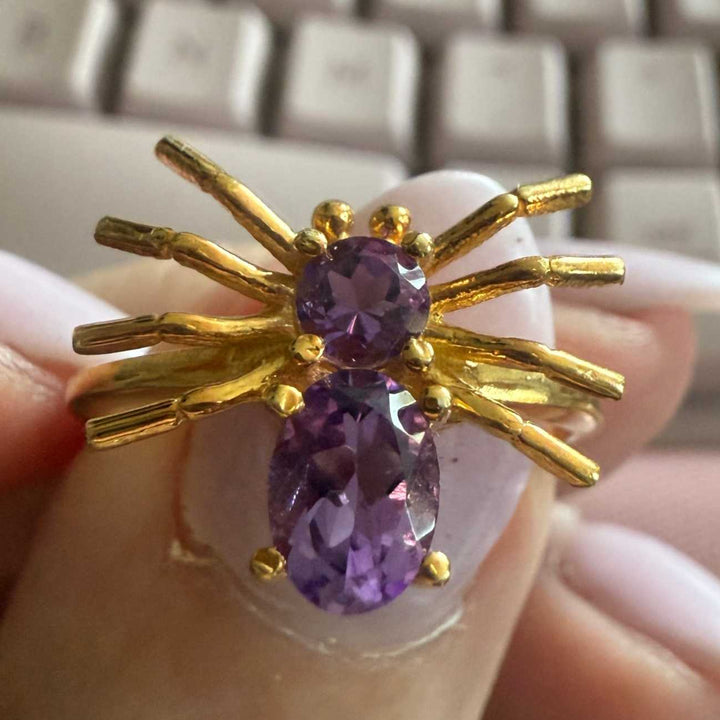 Spider ring with precious metal band and spider legs with gemstone spider body