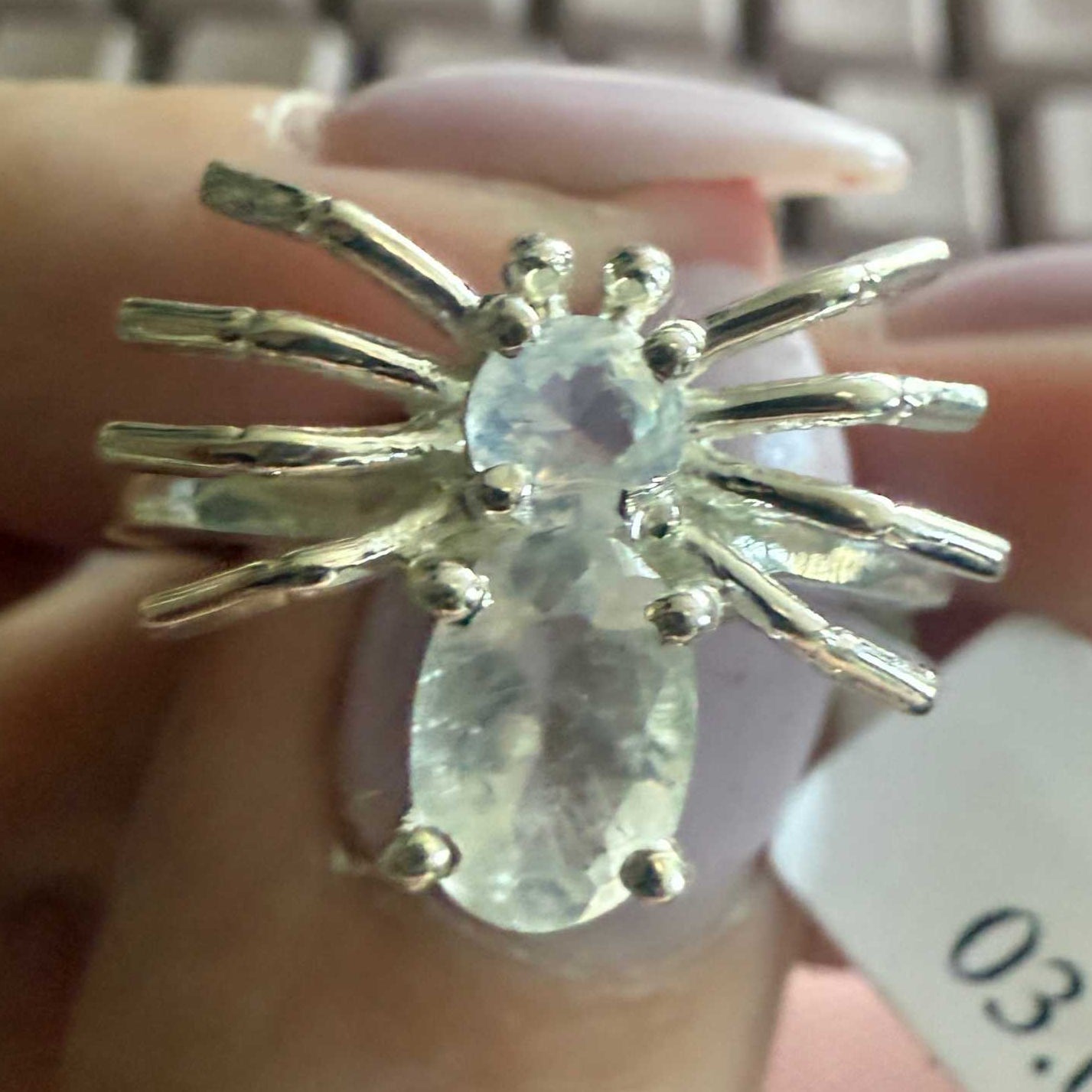 Spider ring with precious metal band and spider legs with gemstone spider body
