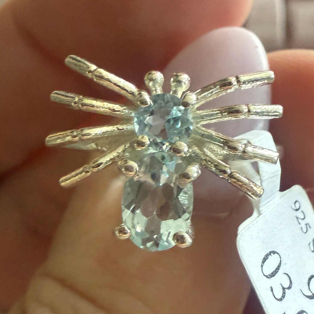 Spider ring with precious metal band and spider legs with gemstone spider body