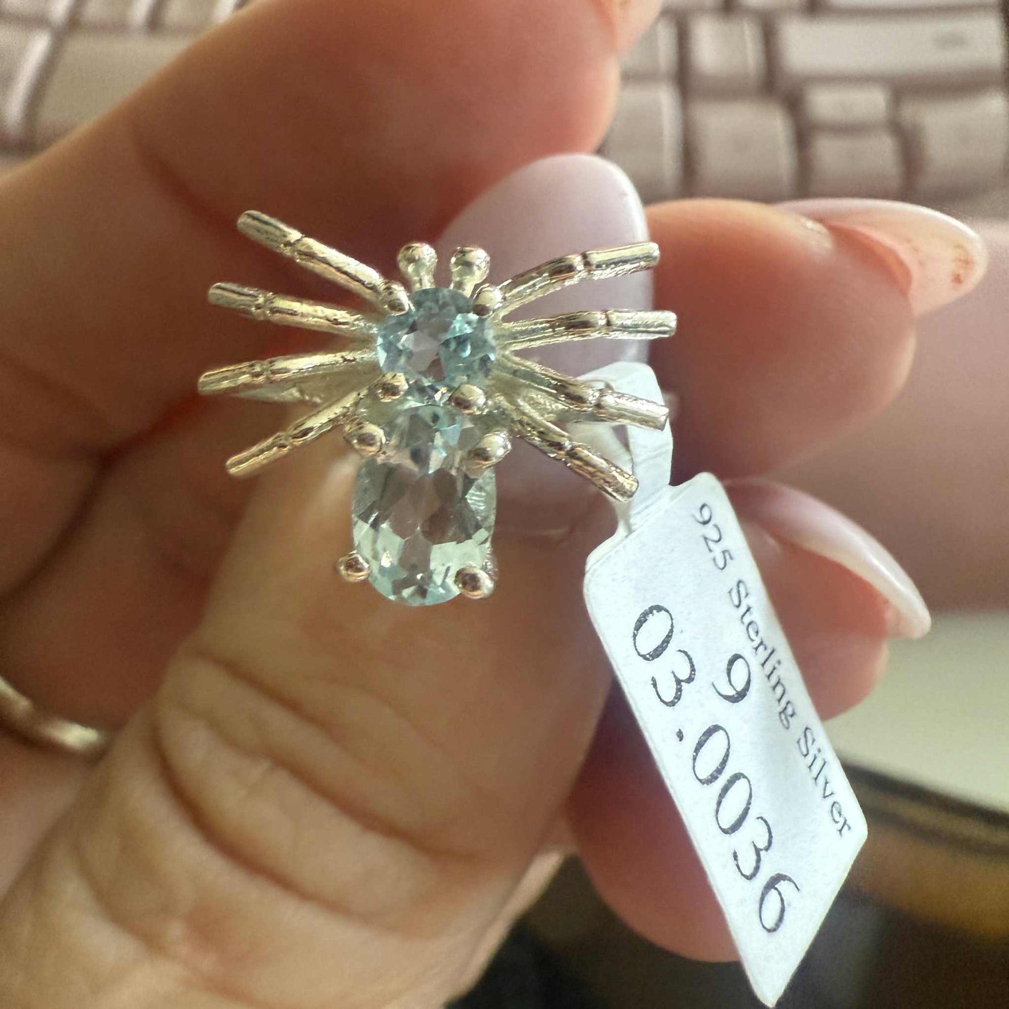 Spider ring with precious metal band and spider legs with gemstone spider body