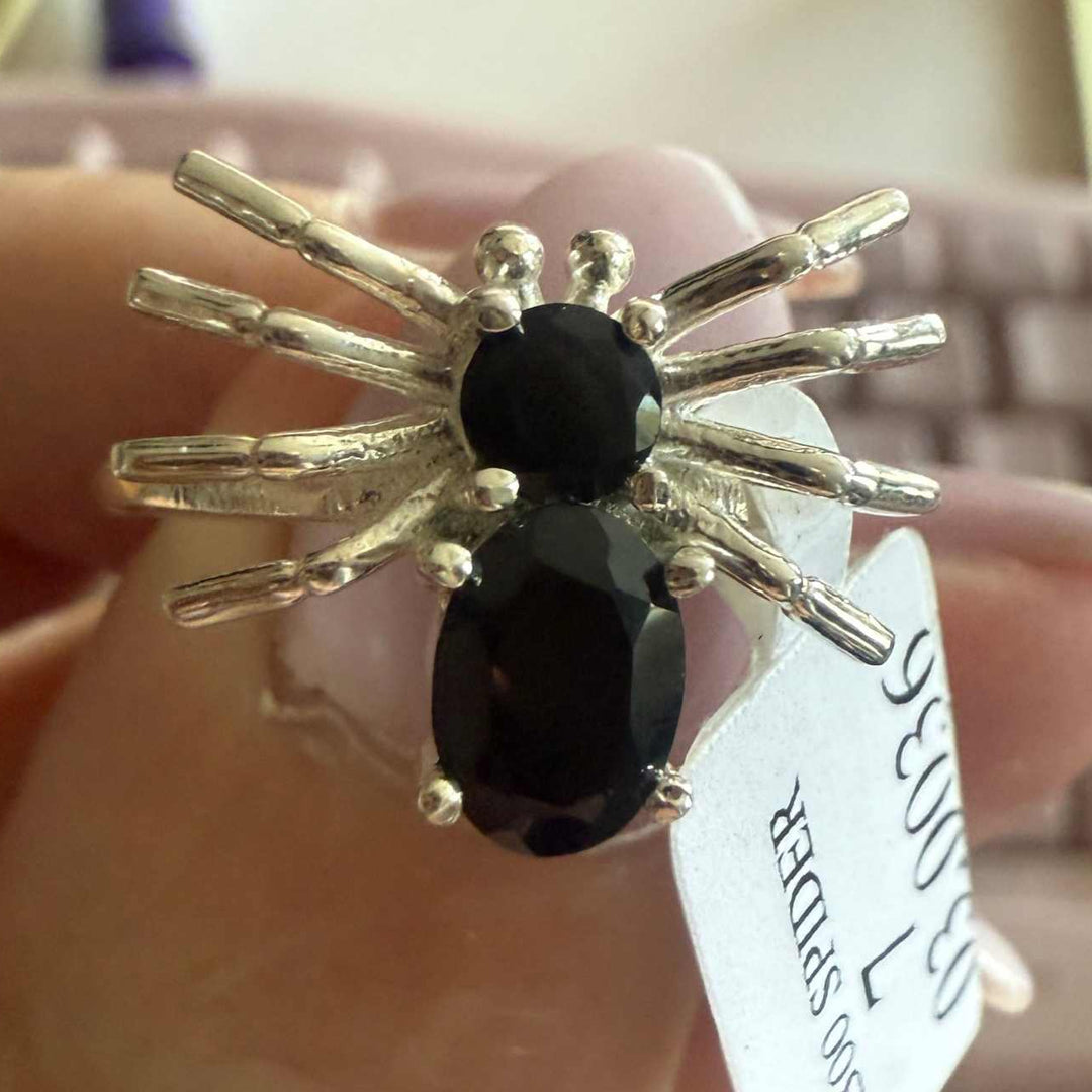 Spider ring with precious metal band and spider legs with gemstone spider body